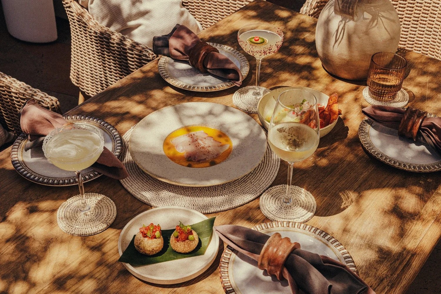 Share plates and margaritas on a table at MAYA