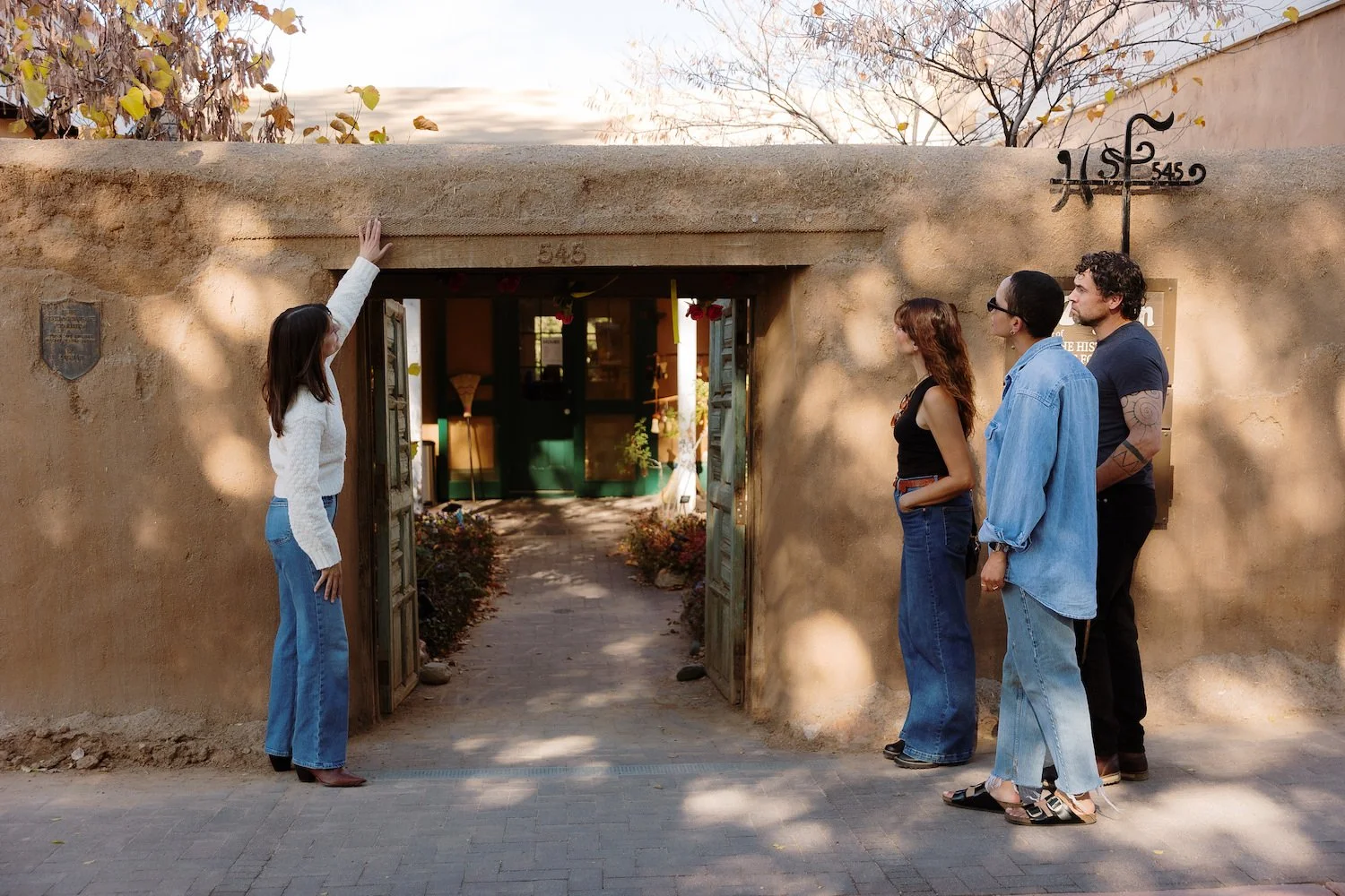 Two women standing in a sculpture garden and enjoying a tour of Canyon Road in Santa Fe