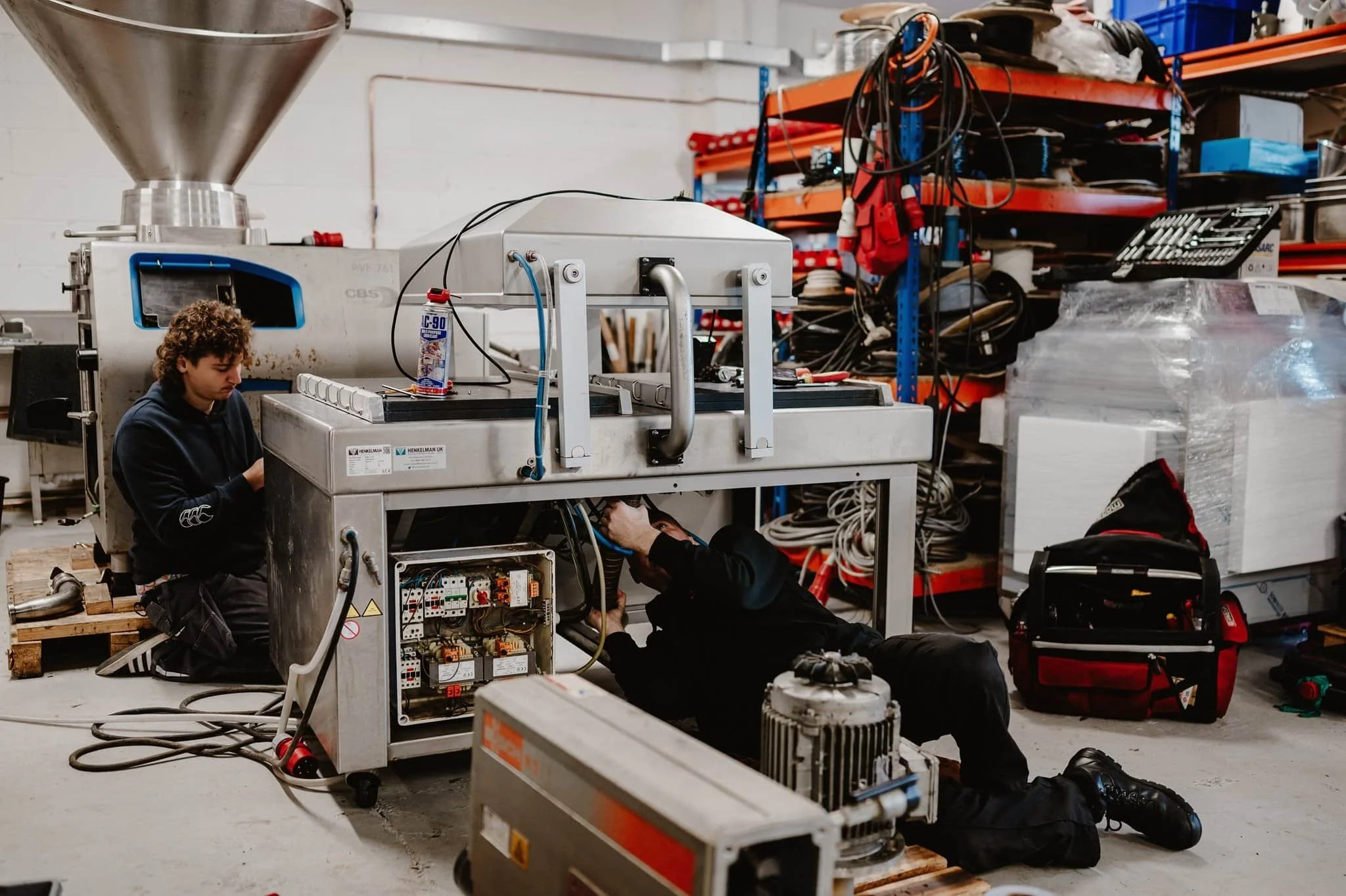 GMSE engineer fixing a vacuum packer machine