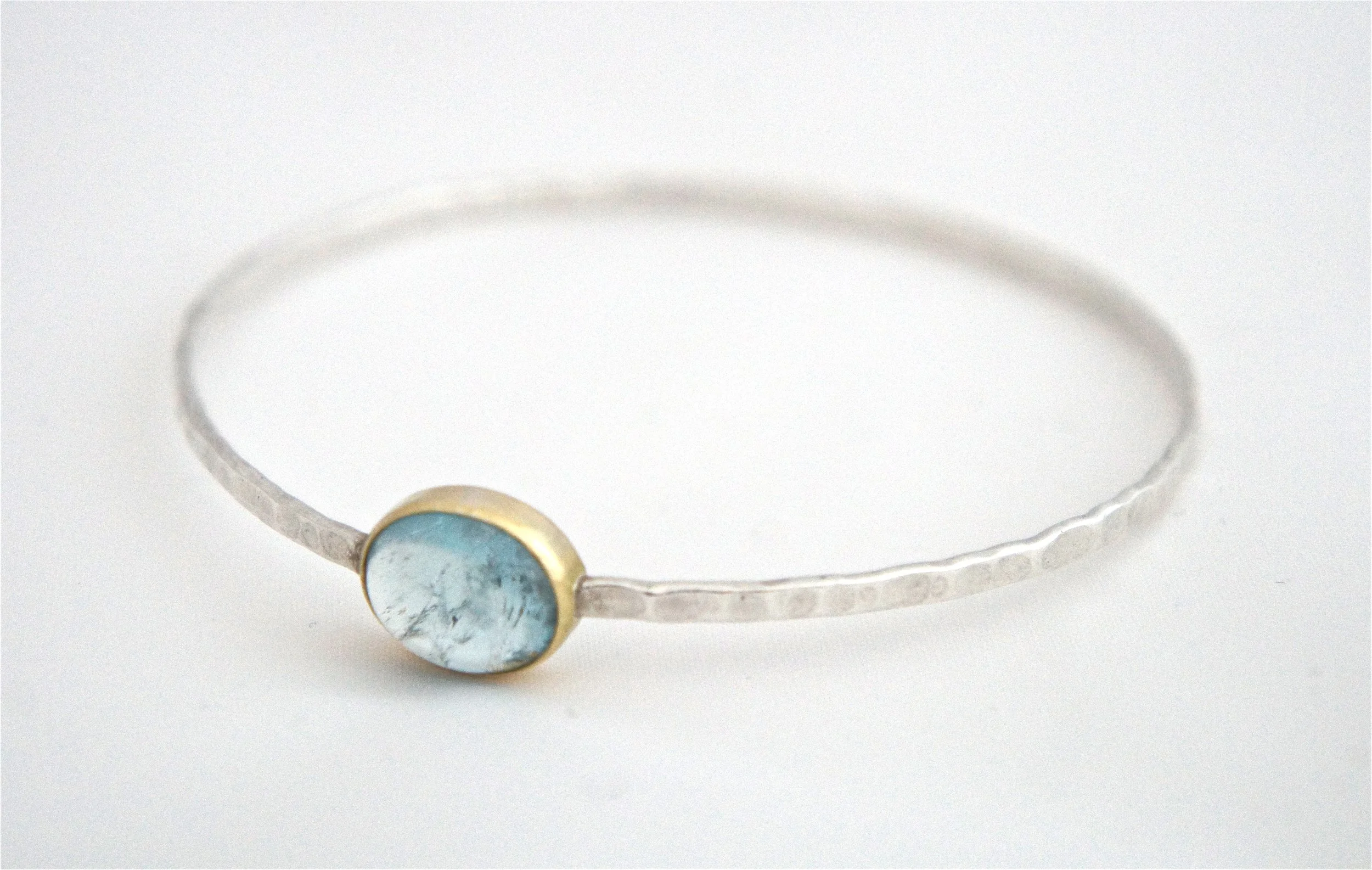 Aquamarine Cabochon set in 18ct Gold on a Silver Bangle