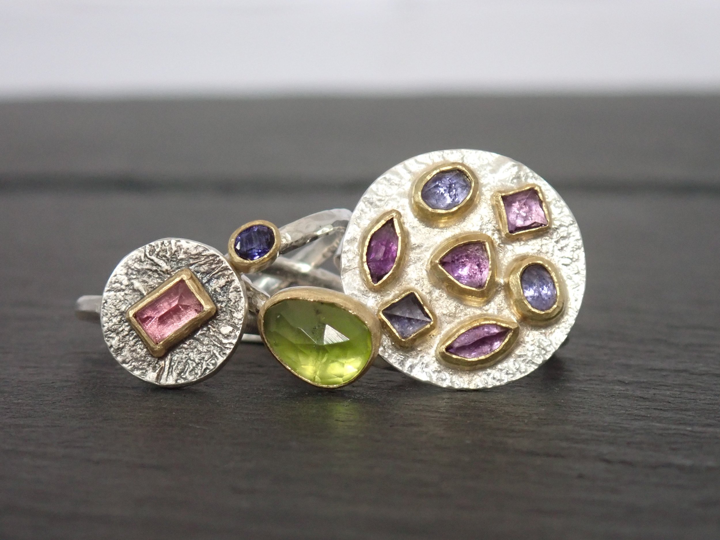 Multiple Silver Rings with 18ct Gold setting containing Tourmaline, Peridot, Iolites and Amethysts