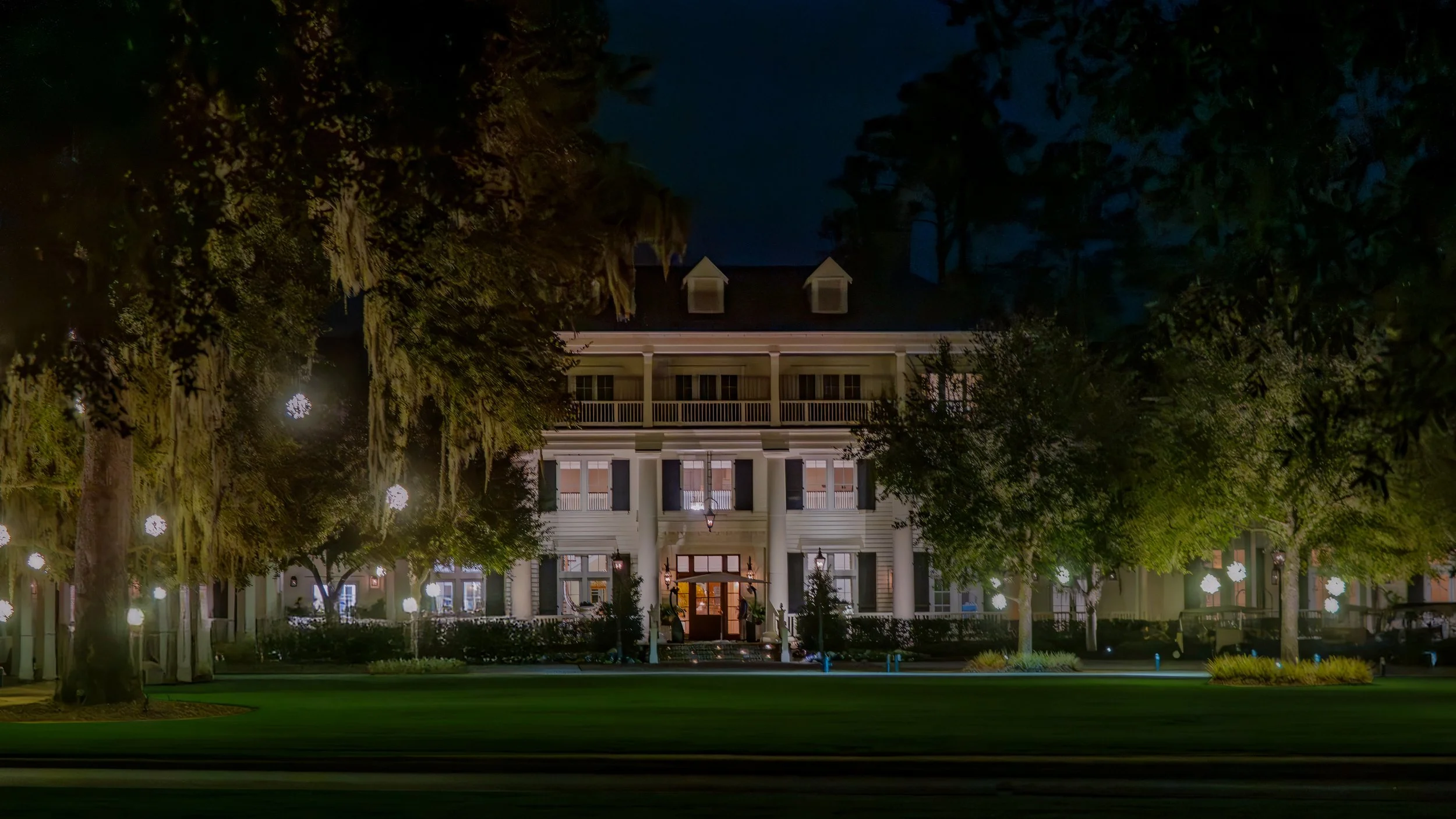 Entrance to Montage Palmetto Bluff illuminated in the evening light with the Lowcountry landscape surrounding the luxury resort in Bluffton South Carolina