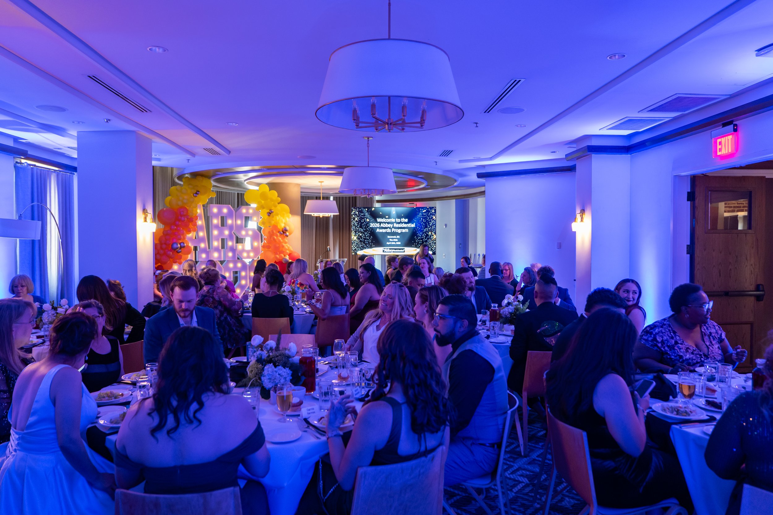 Guests gather for a corporate dinner and awards reception inside a private rooftop ballroom at The Alida Hotel in Savannah, Georgia.