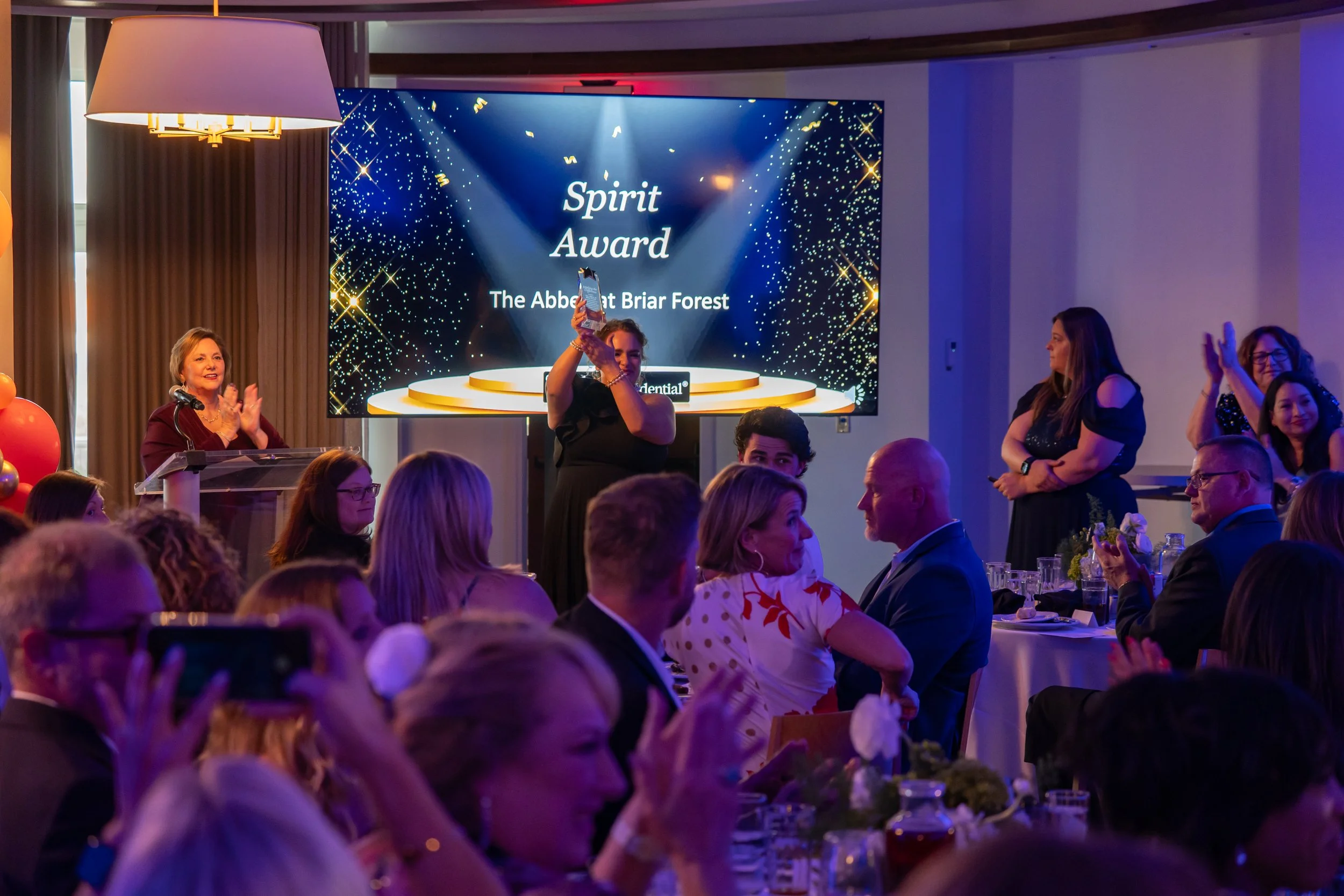 Guests applaud and celebrate during a corporate awards ceremony at The Alida Hotel in Savannah, Georgia.