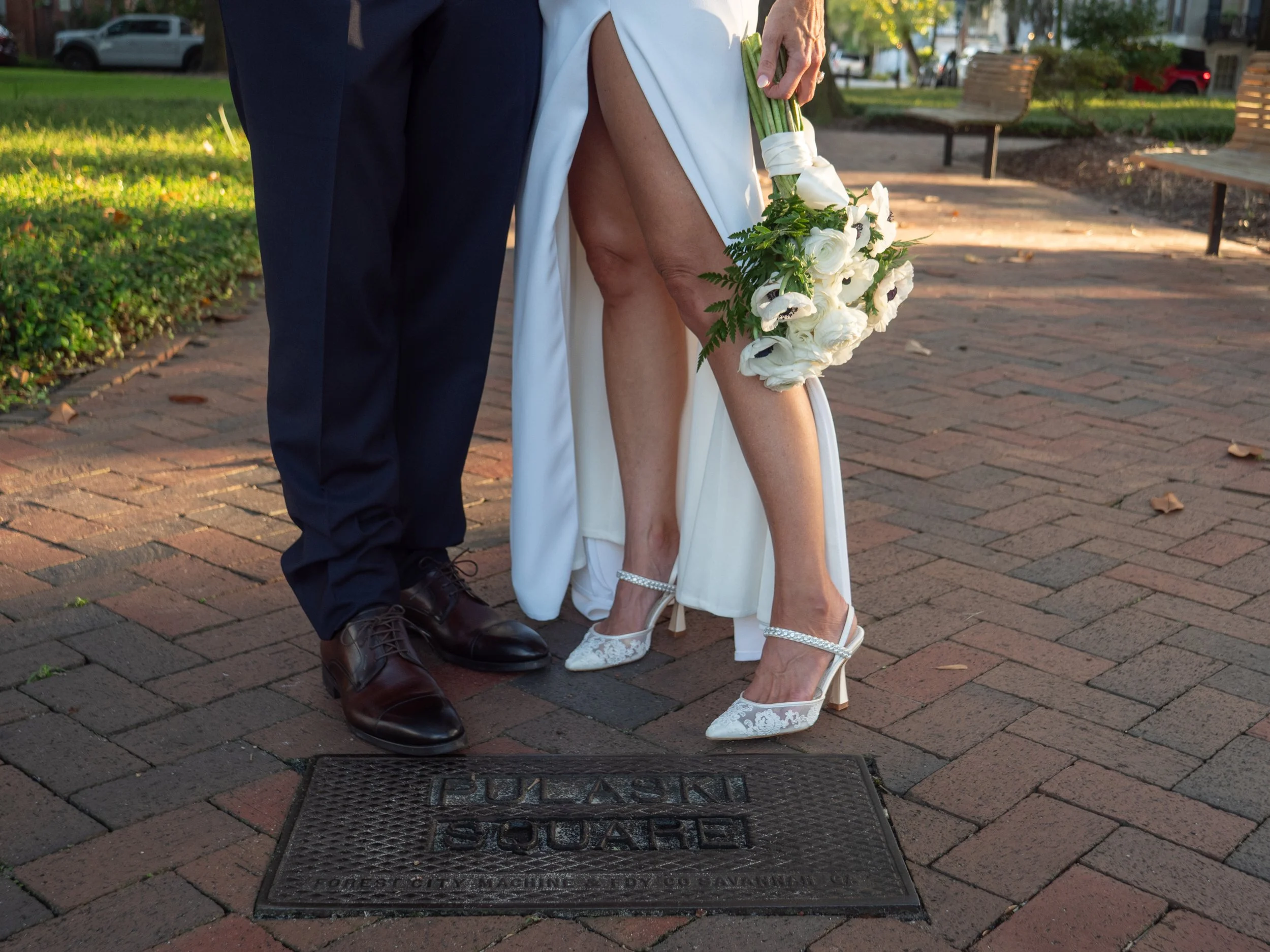 Bride and groom standing together above the Pulaski Square ground marker