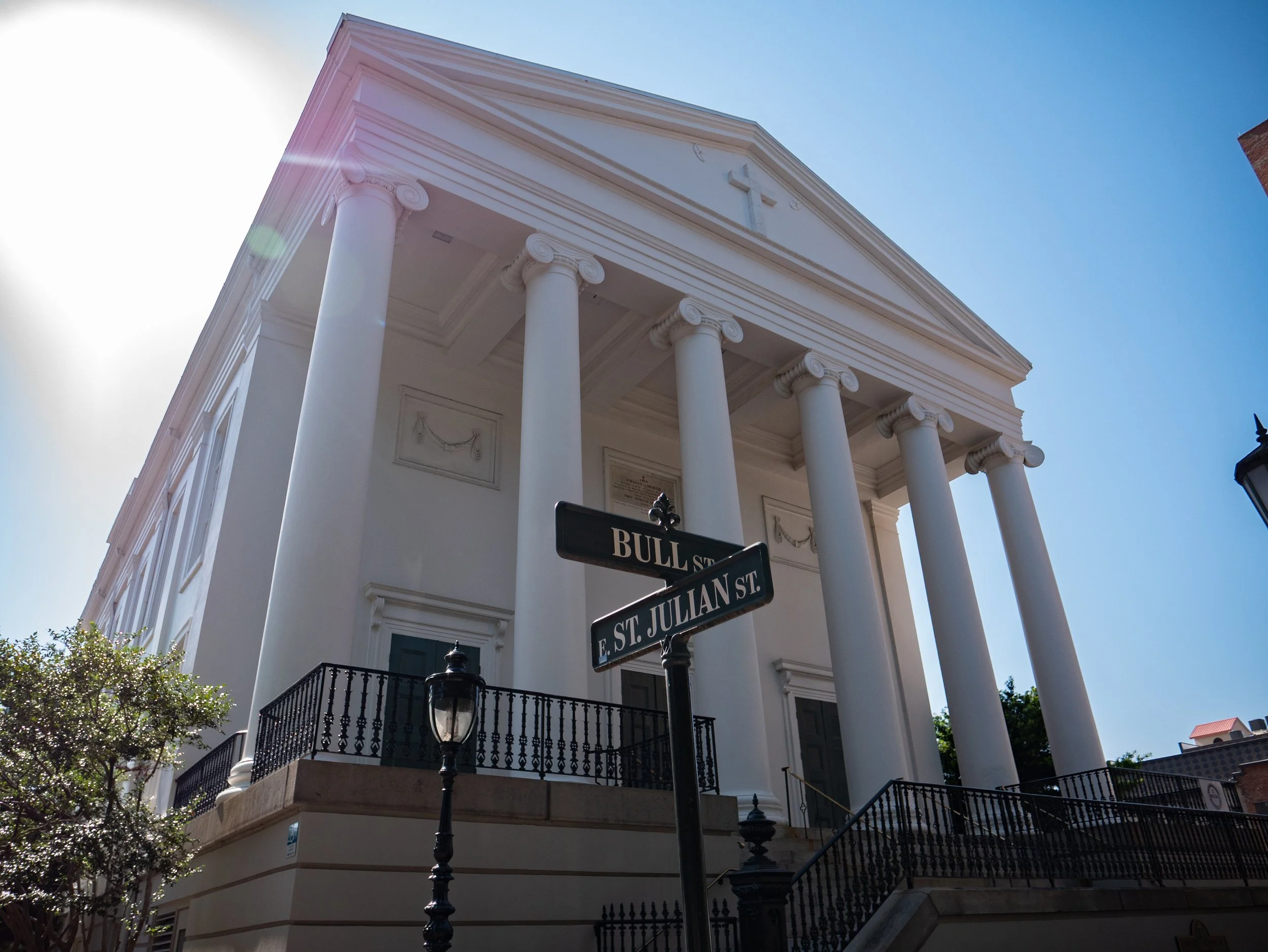 Christ Church Episcopal beside the Bull Street and East St. Julian Street signs in Savannah.