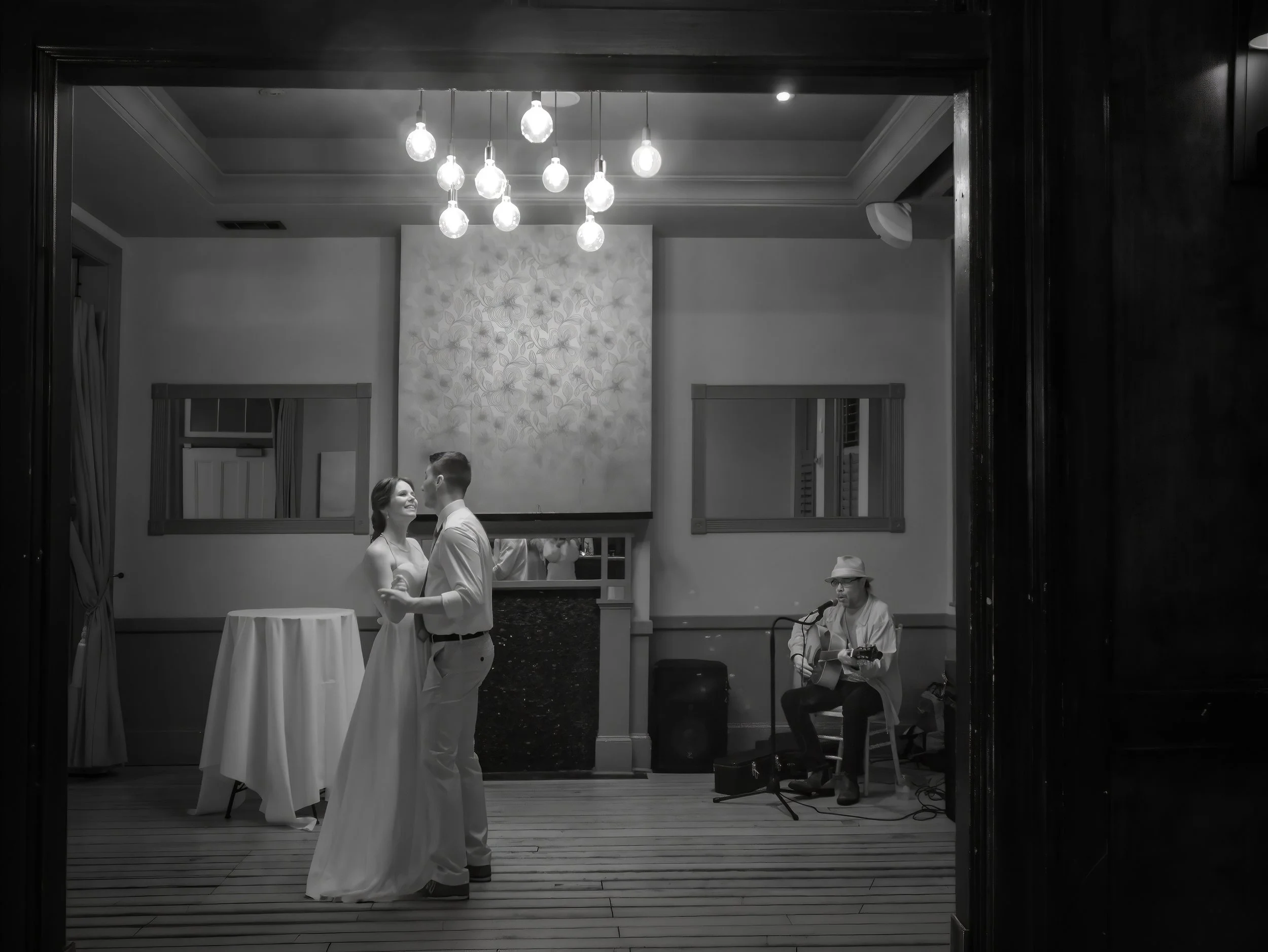 Tim and Daniella share their first dance in a fine art infrared black and white photograph as Savannah musician Ray Lundy performs.