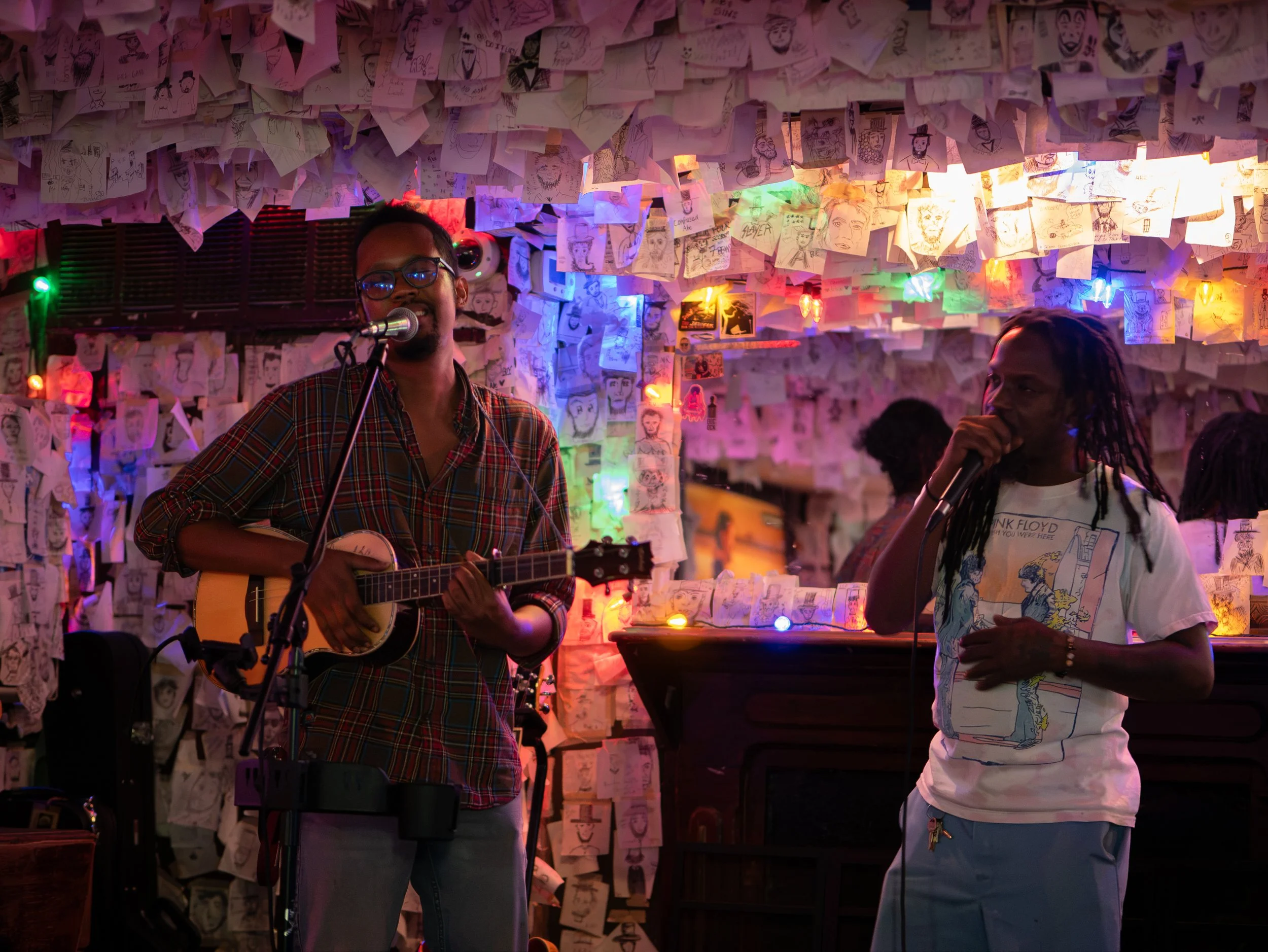 Steven, known as BasikLee, and Alvin perform together beneath Lincoln drawings at Abe’s