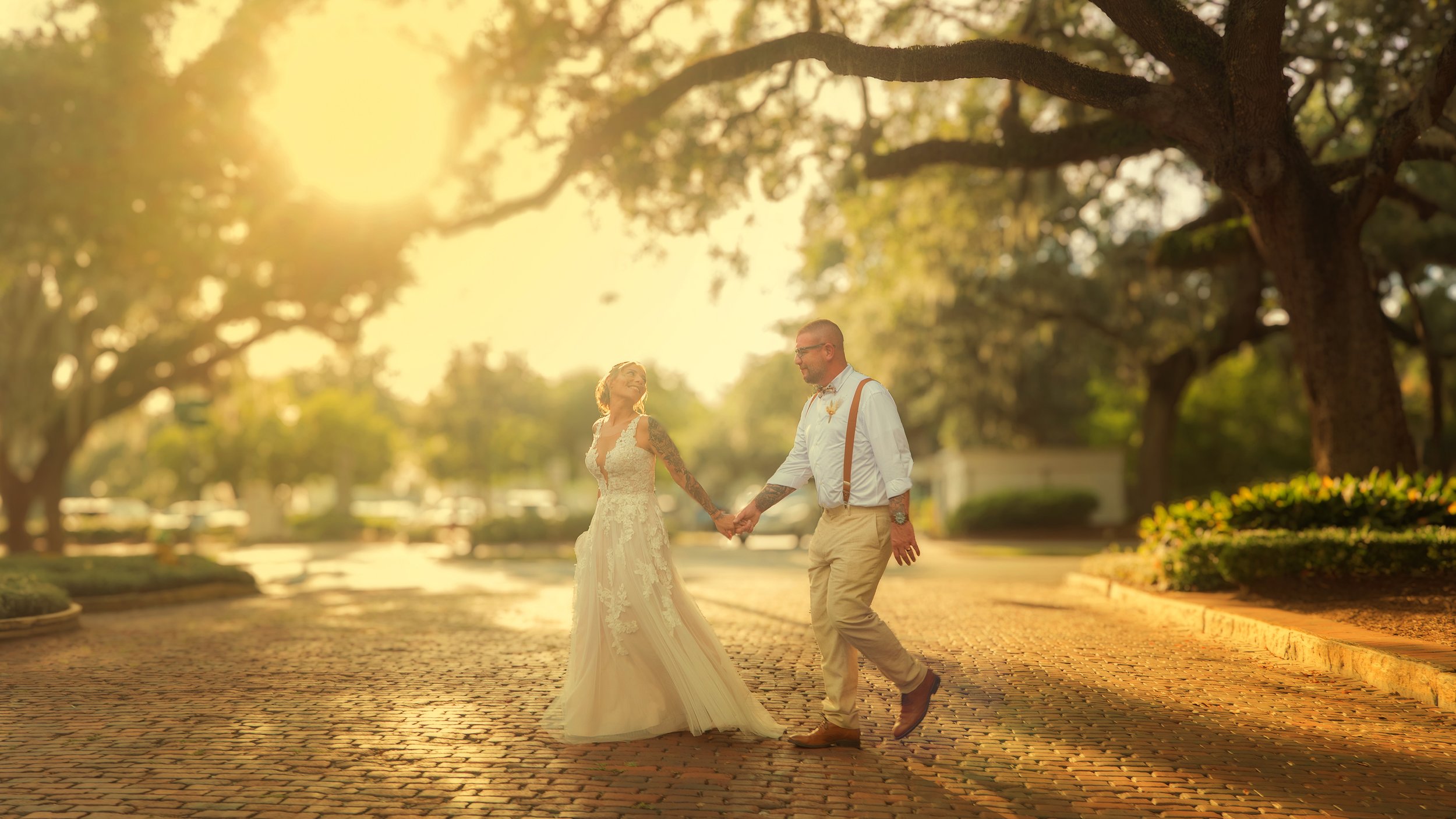 Bride and groom walk the historic cobblestone streets of downtown Savannah, Georgia during a romantic wedding portrait session in the Historic District.