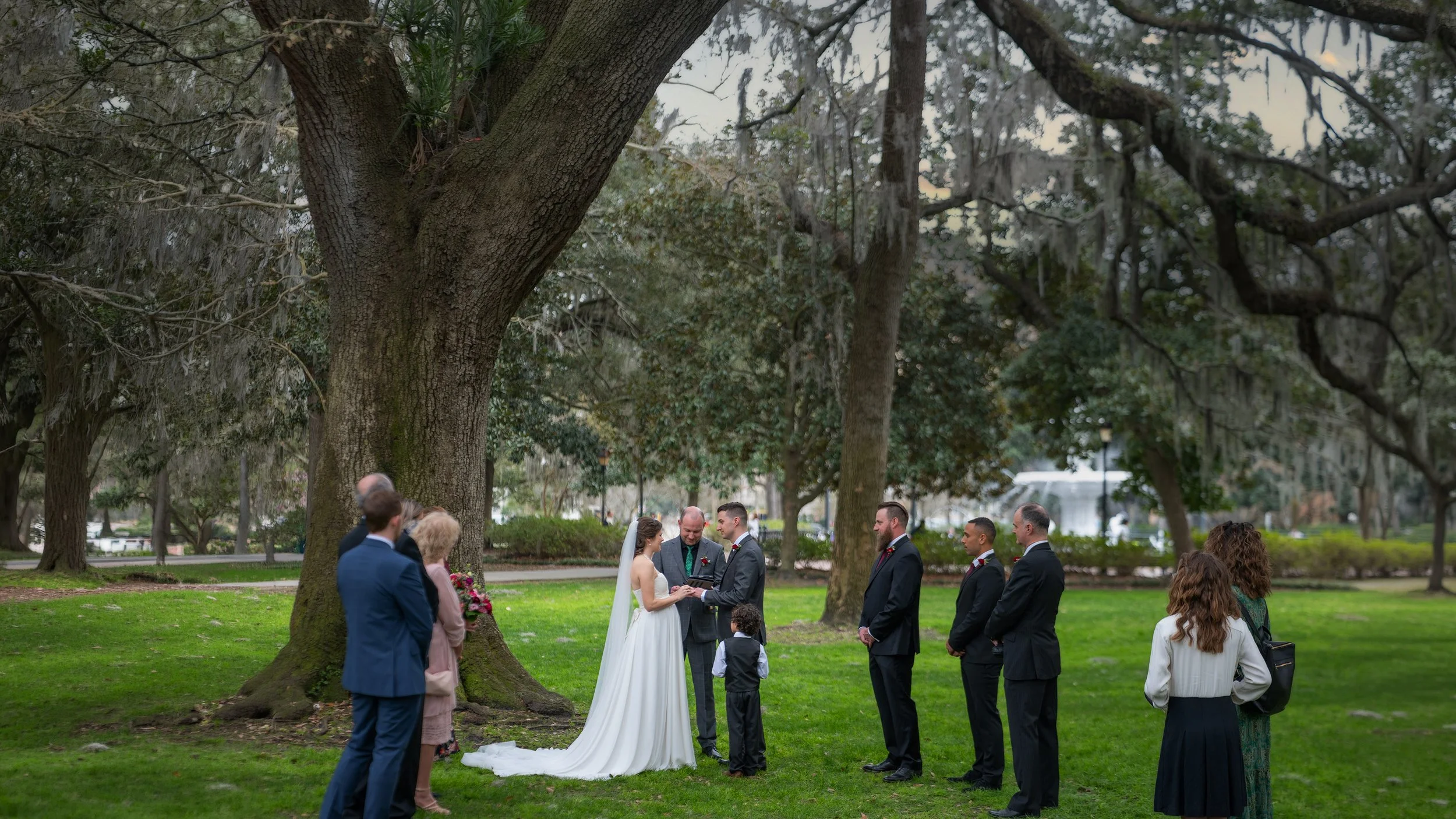 Tim and Daniella exchange vows beneath the live oaks during their intimate Savannah micro wedding in Forsyth Park.