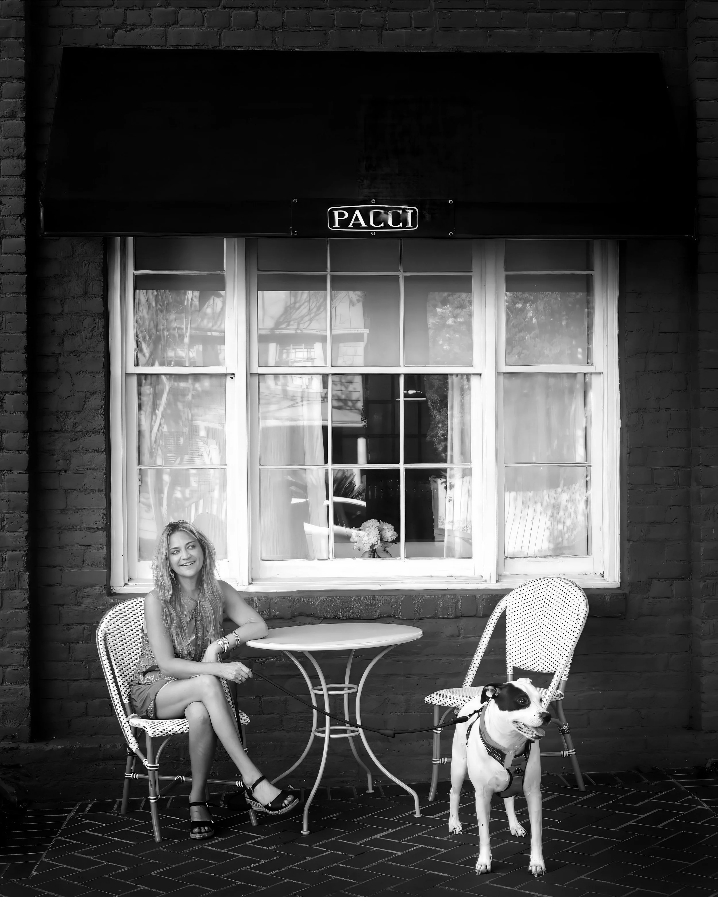 Jennifer Maring and Sugar relax outside Pacci Italian Kitchen at Kimpton Brice in Savannah.