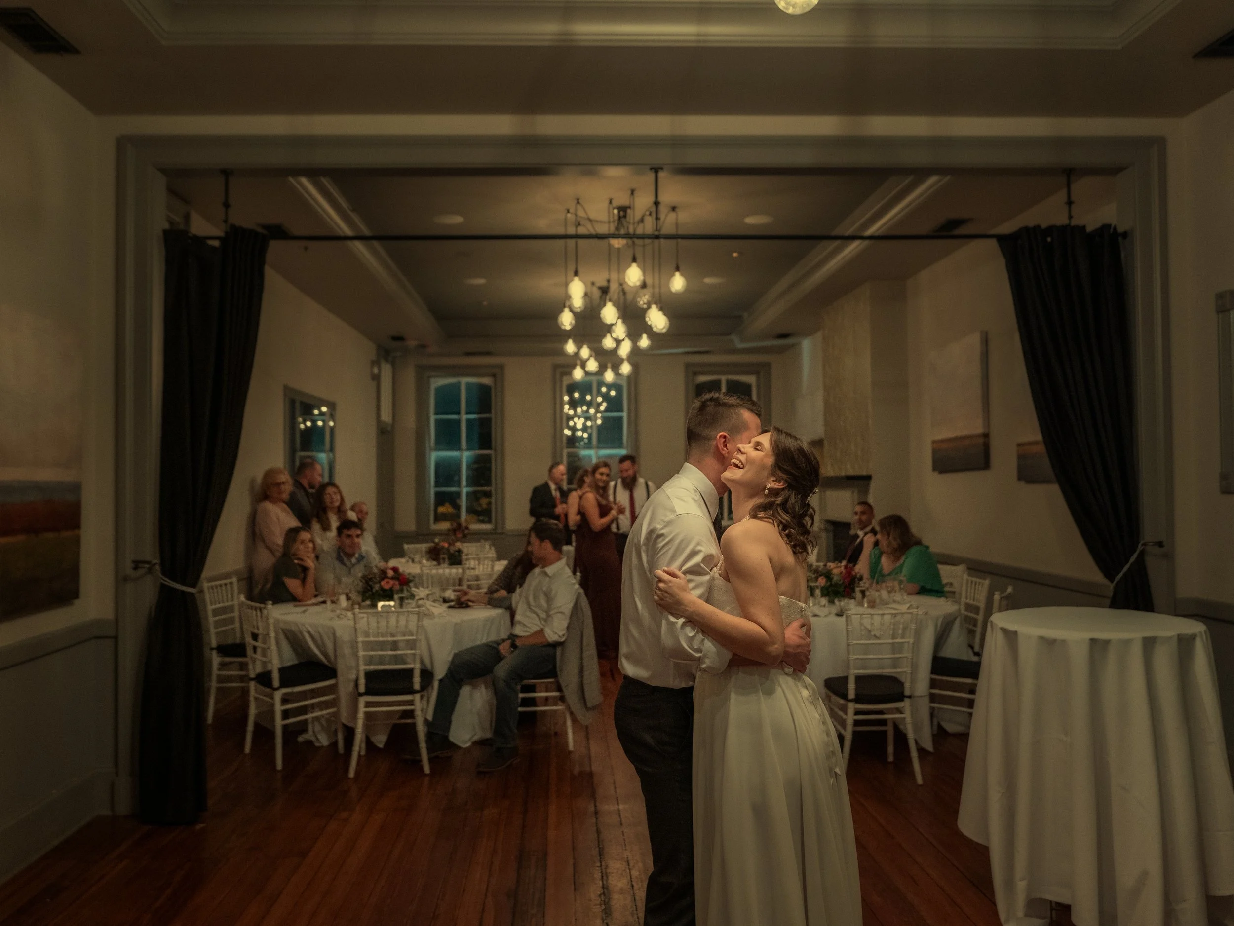 Bride and groom share a joyful first dance as guests look on during their Savannah micro-wedding.