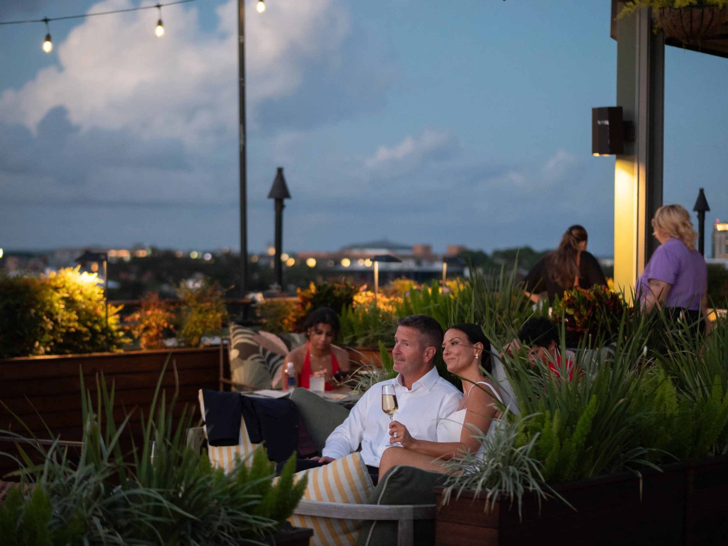 Newlyweds relaxing together with champagne on the Perry Lane Hotel rooftop