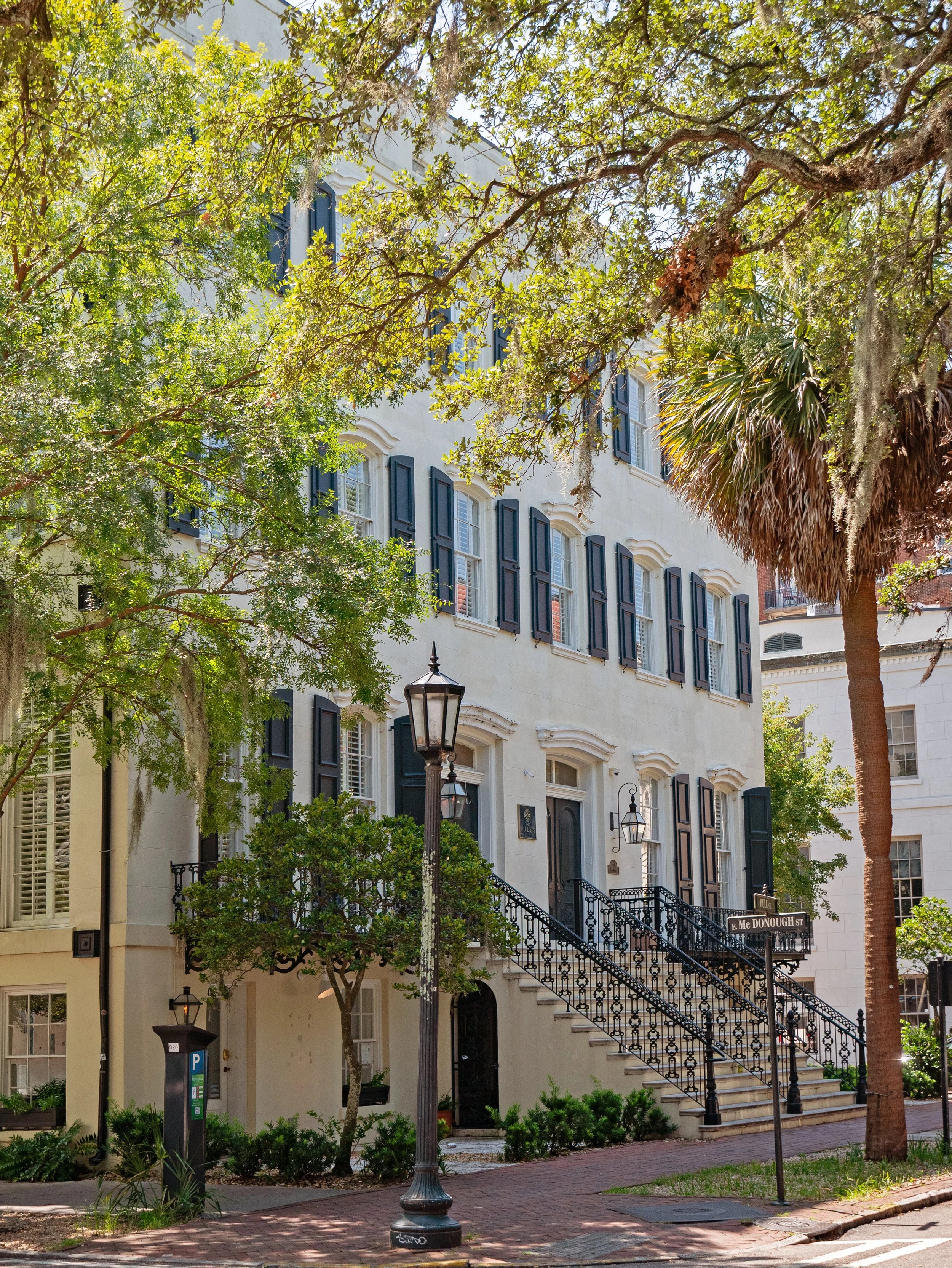 The Jules exterior on Chippewa Square with dark shutters, tall windows, and ornate iron stair railings.