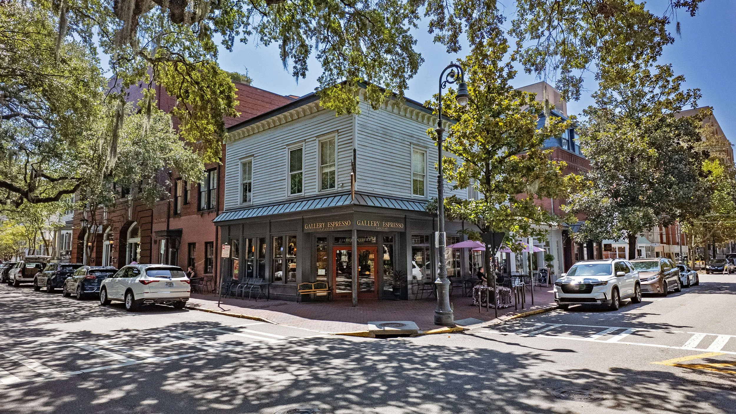 Gallery Espresso’s corner storefront beneath trees beside Chippewa Square in Savannah.
