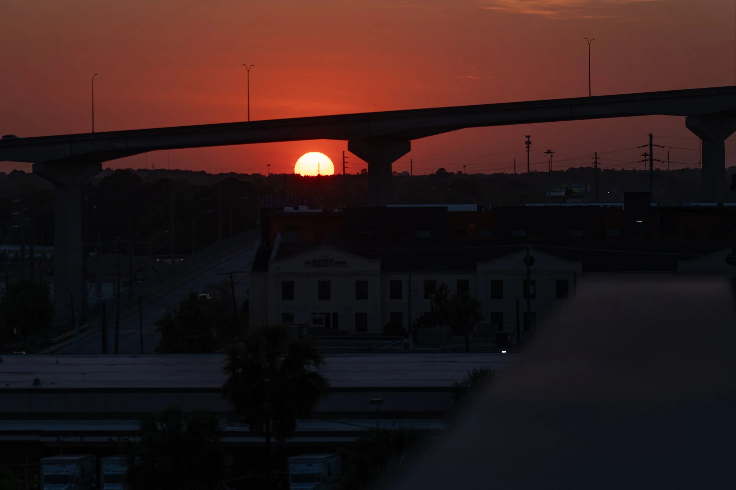 Sunset beneath the Talmadge Memorial Bridge as viewed from The Lost Square rooftop bar at The Alida Hotel in Savannah.