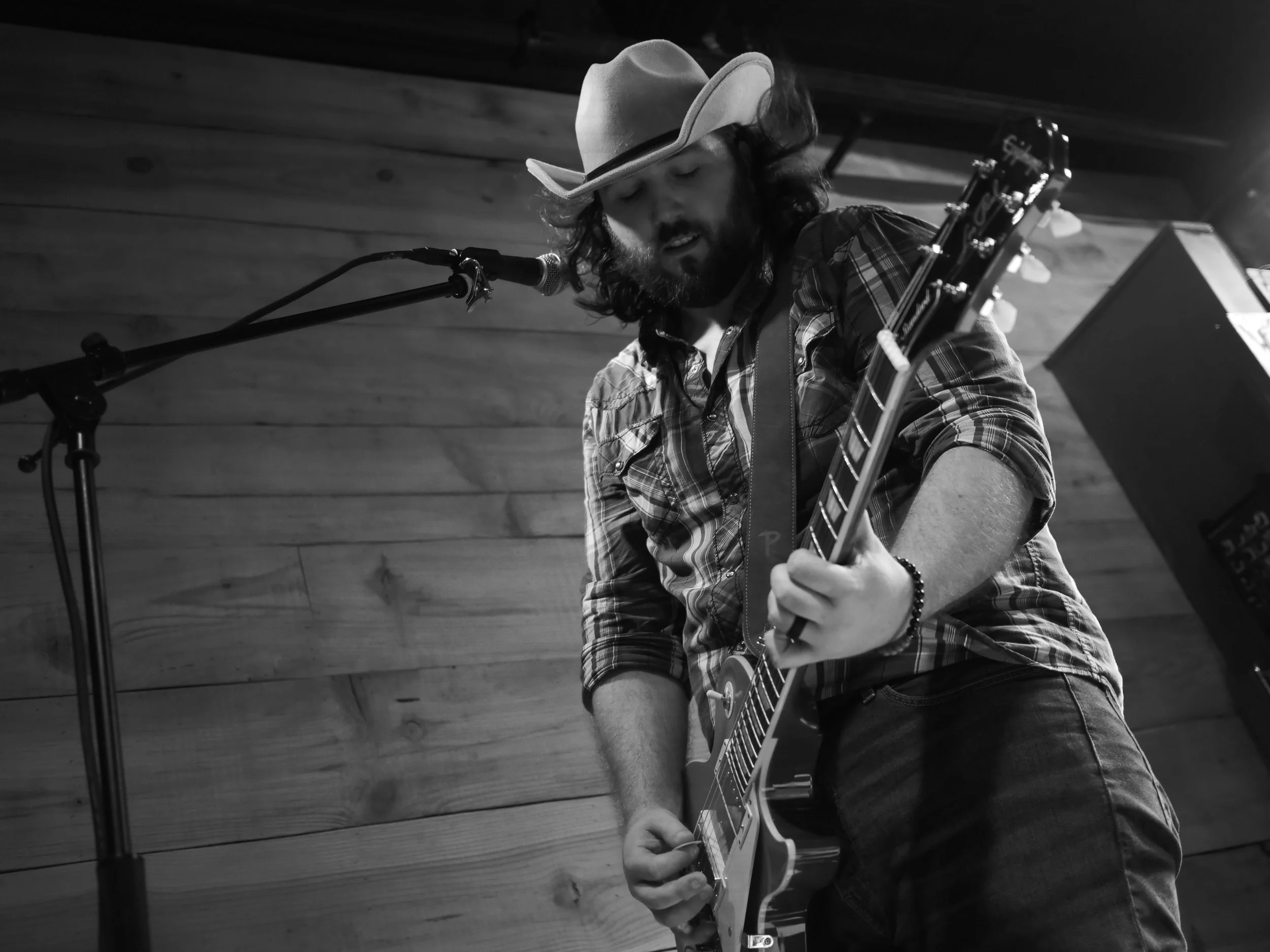 Delta Circle vocalist and guitarist Nic Ziter performing in a cowboy hat at Honky Tonk South in Savannah.
