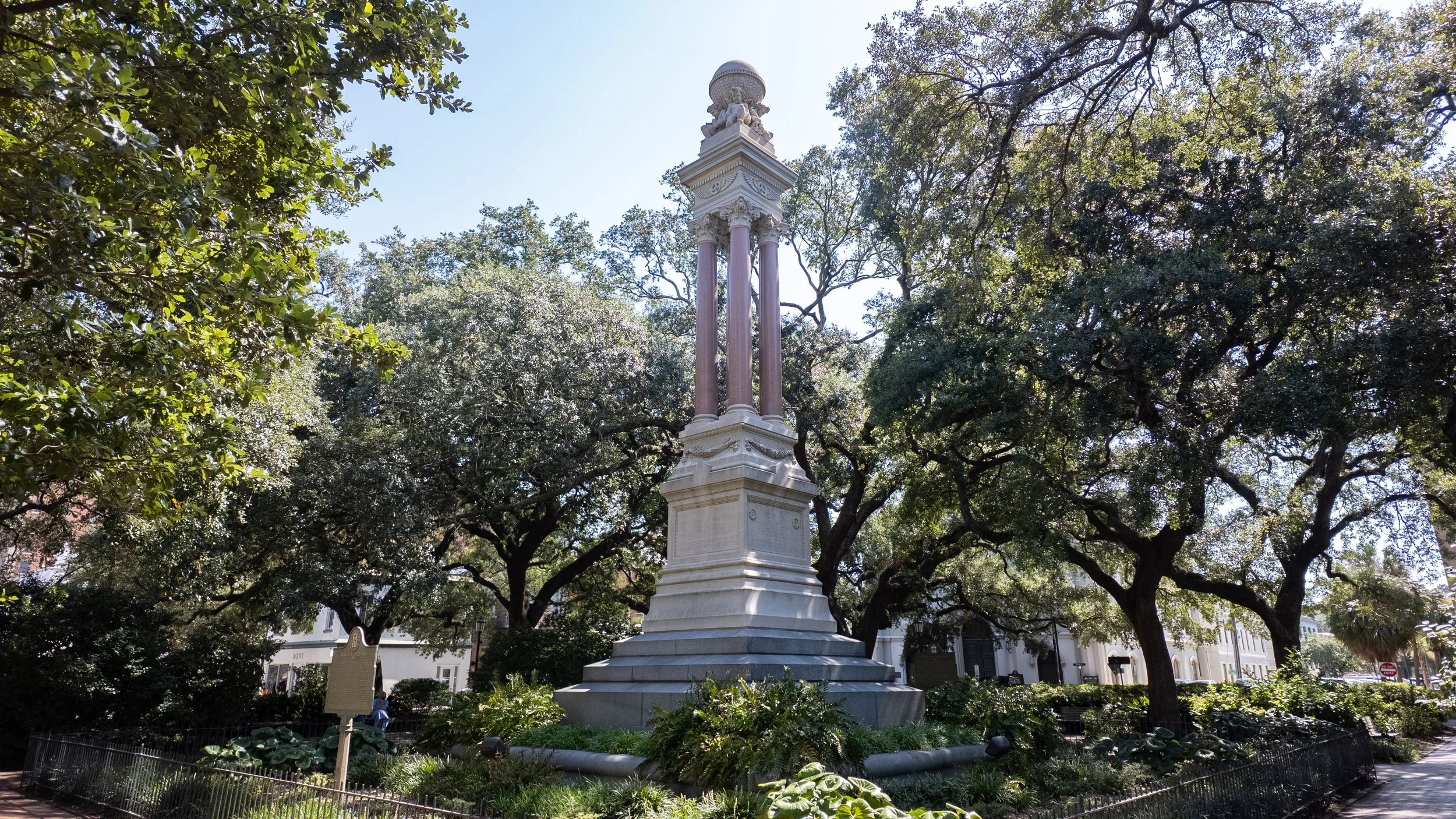 Gordon Monument framed by live oak branches and landscaping in Wright Square