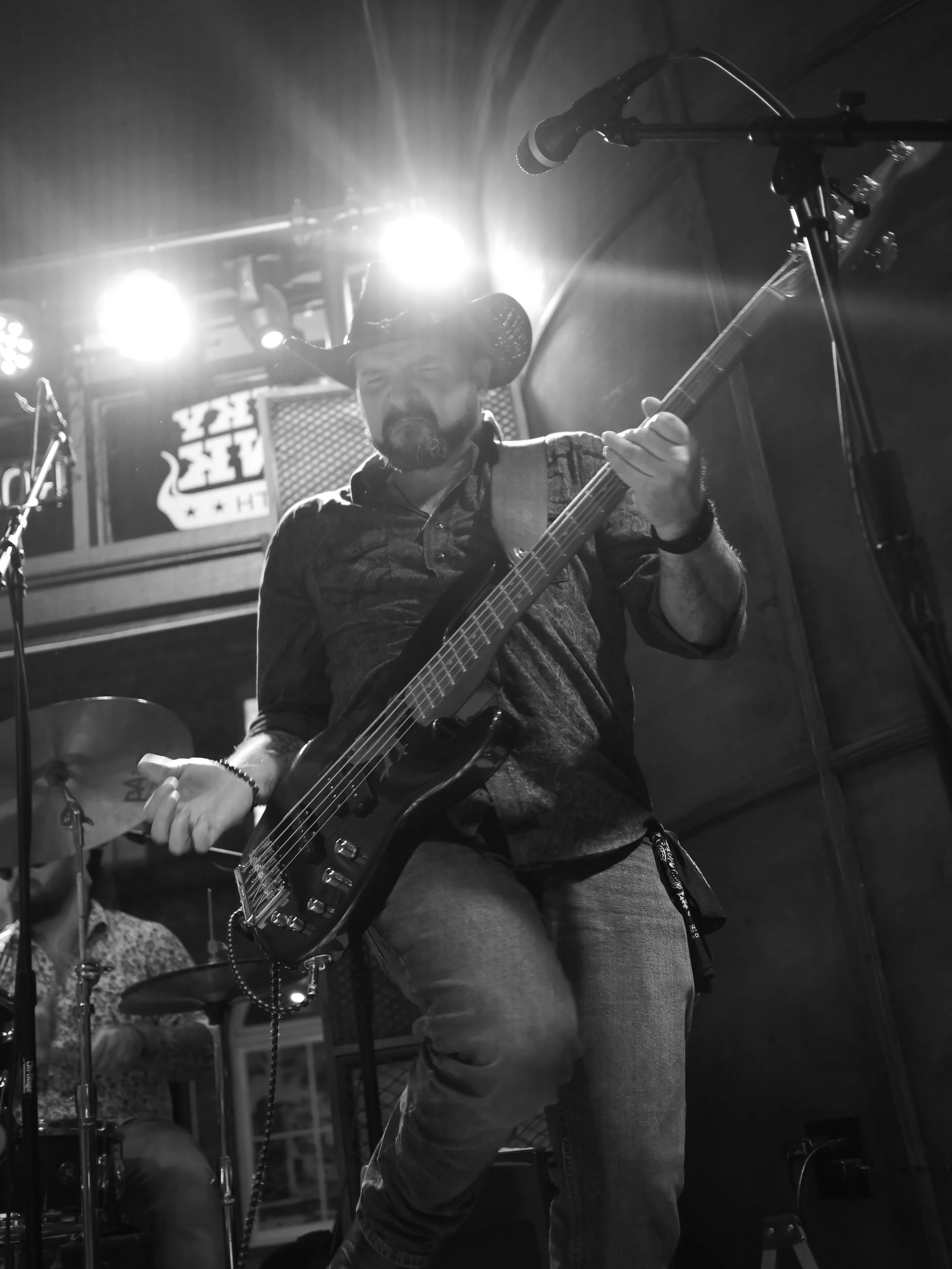 Delta Circle bassist Earnest Spiva performing beneath stage lights at Honky Tonk South in Savannah.