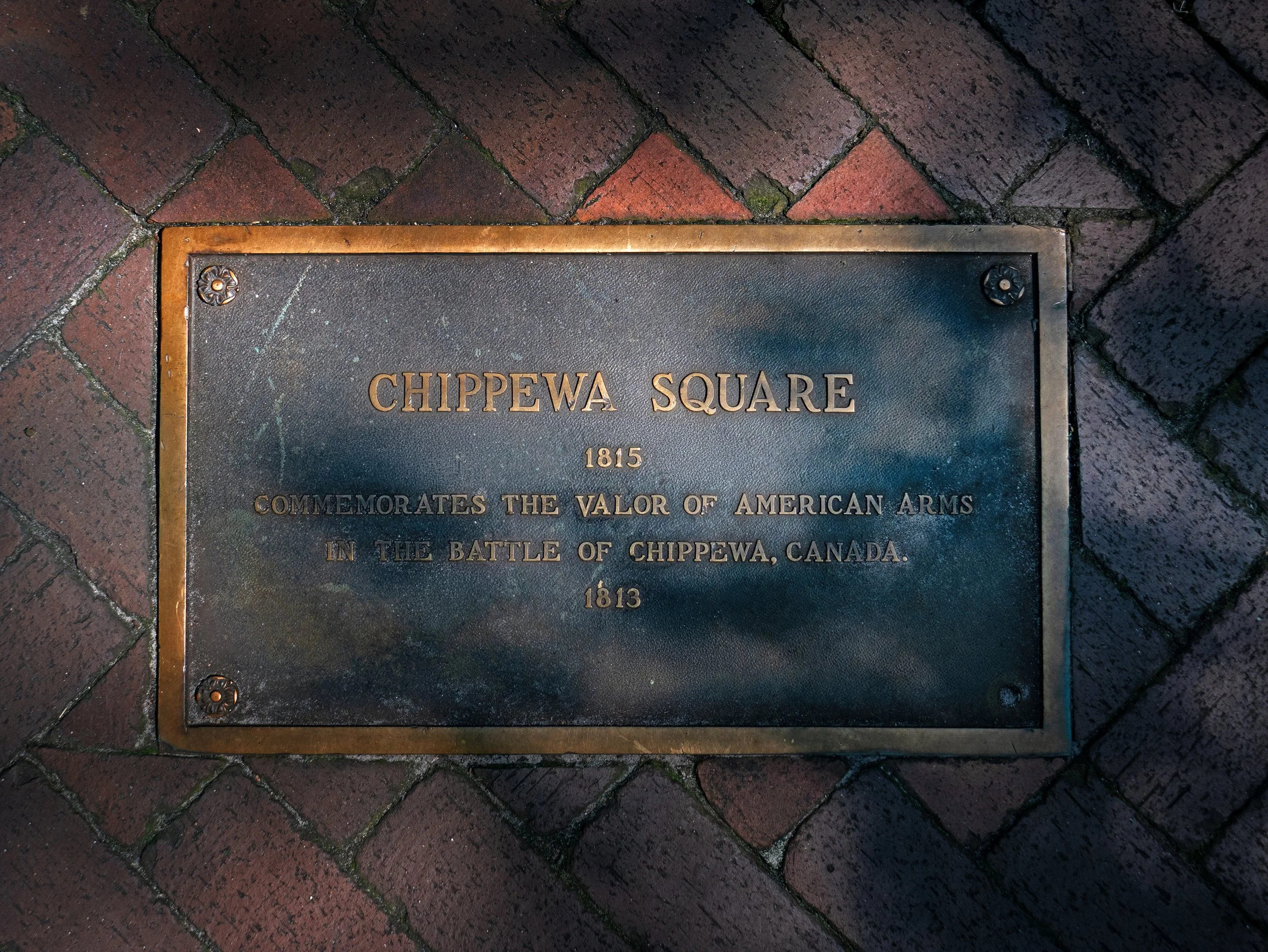 Bronze Chippewa Square plaque set into brick paving, commemorating the Battle of Chippawa.