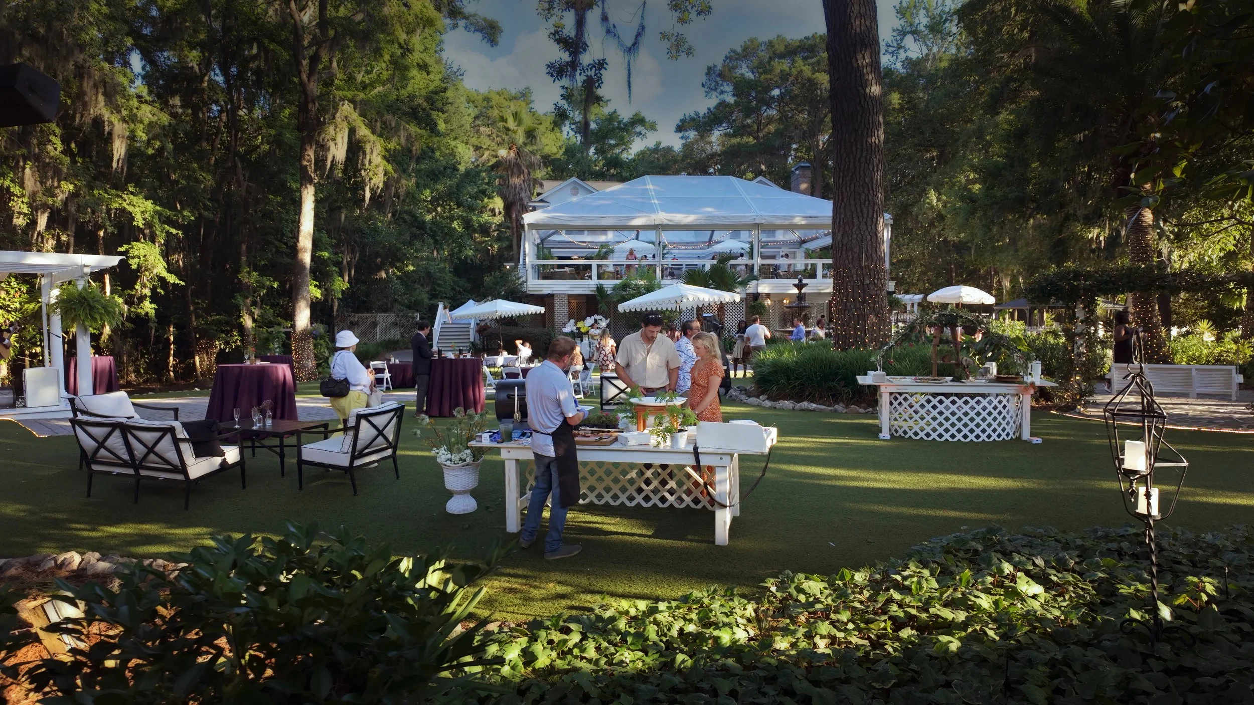 Guests enjoy gourmet food and conversation in the garden during a corporate event at The Mackey House in Savannah.