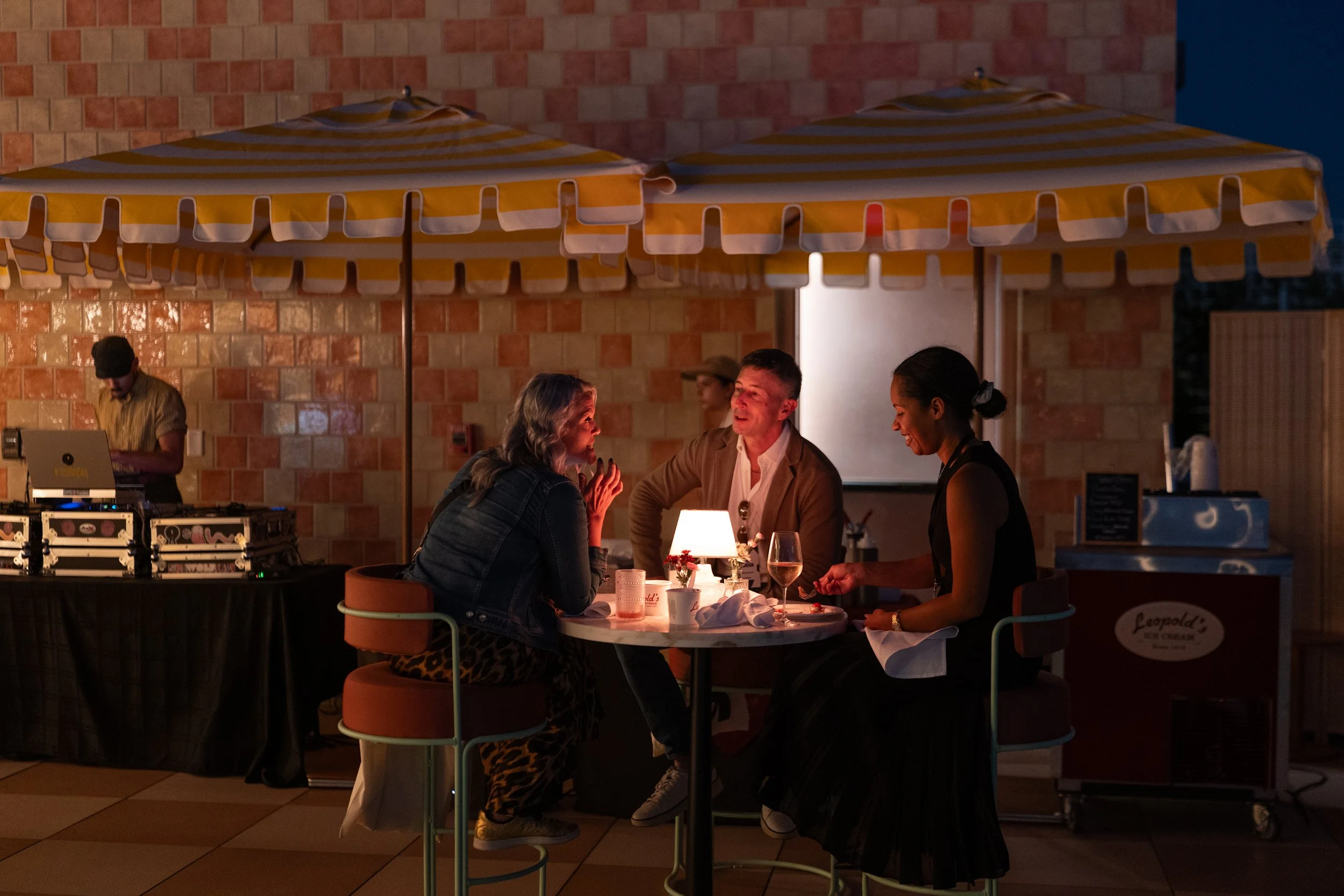Guests enjoying drinks and conversation at the rooftop bar at Recess Hotel & Club in downtown Savannah.