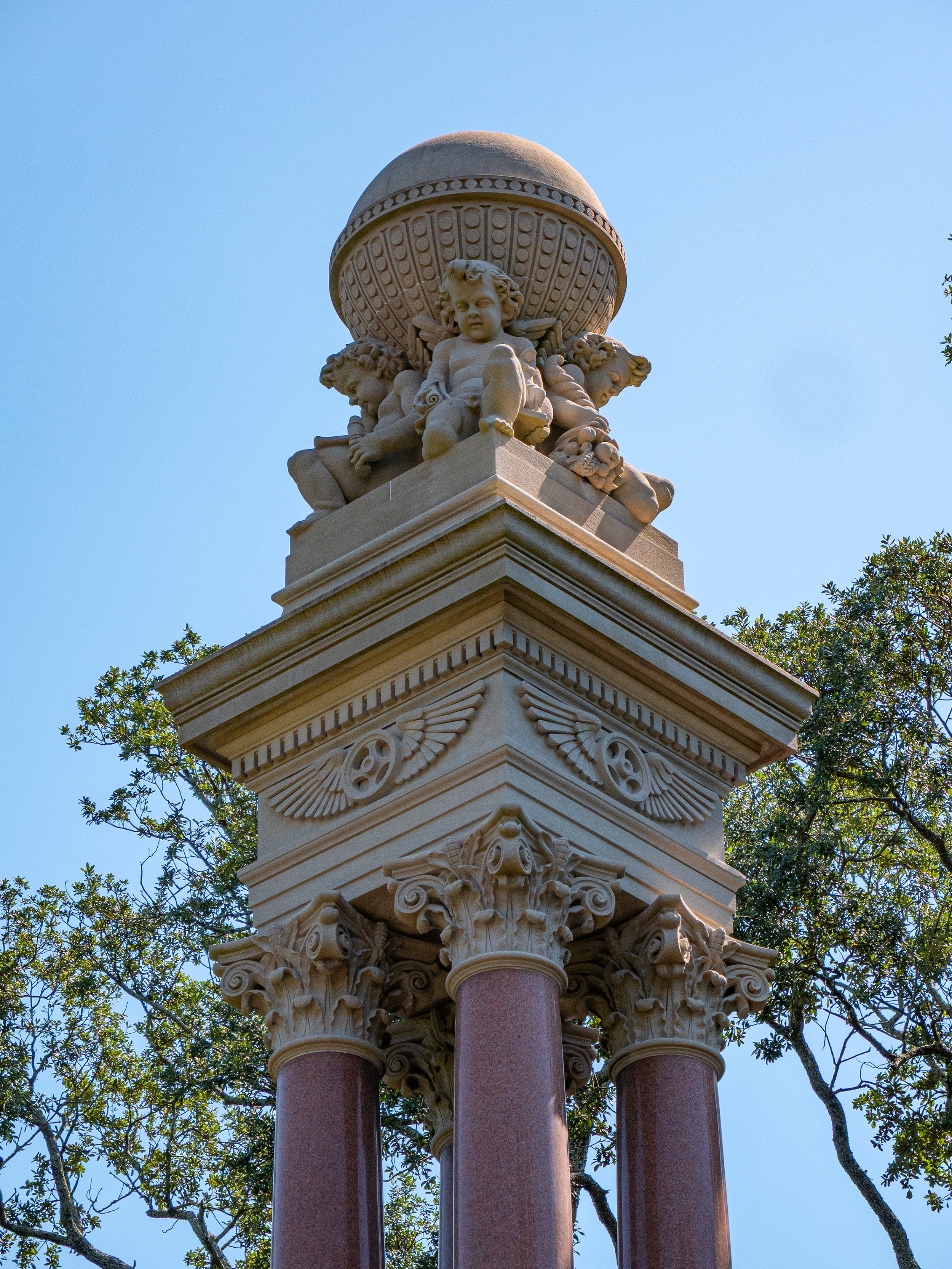 Cherubs, carved ornament, and red granite columns on the Gordon Monument