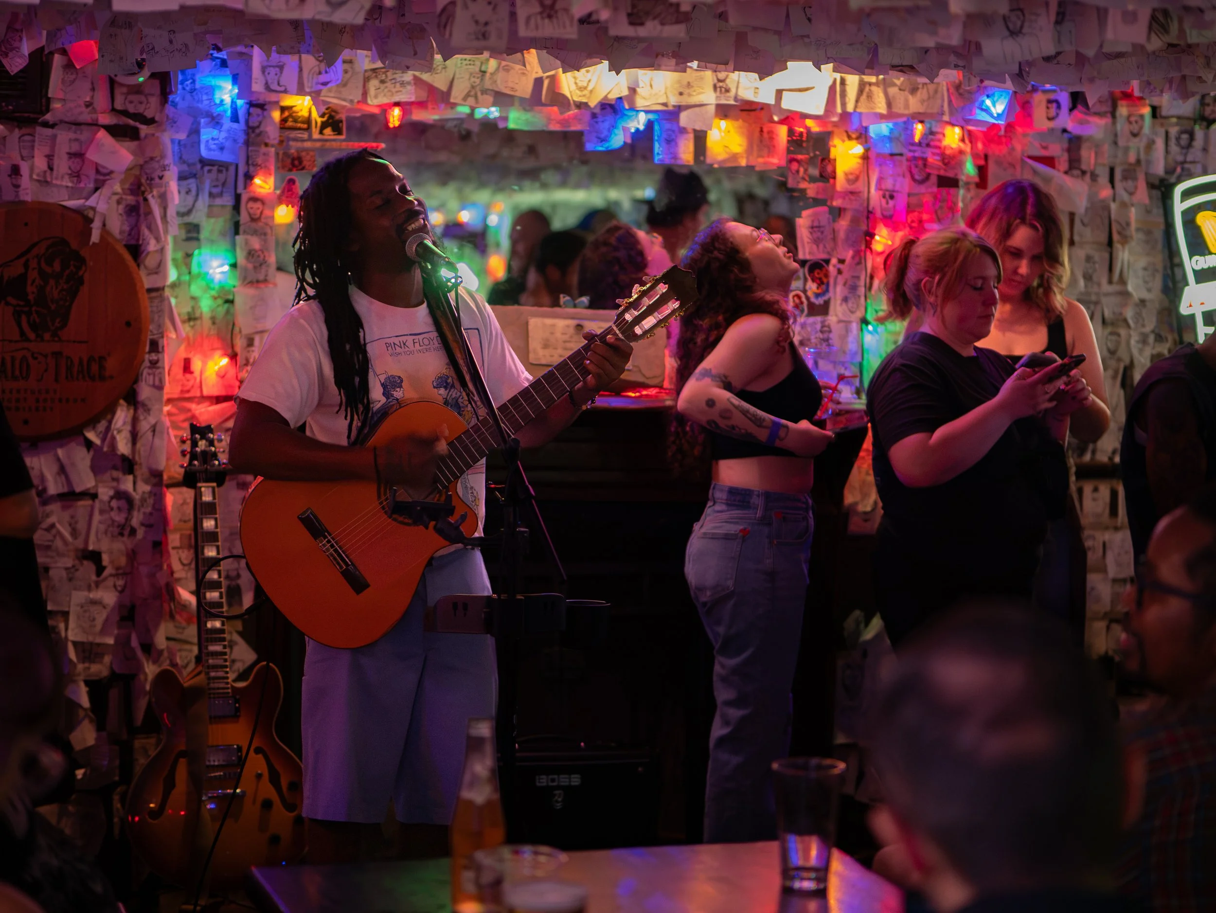 BasikLee sings and plays acoustic guitar during open mic at Abe’s on Lincoln