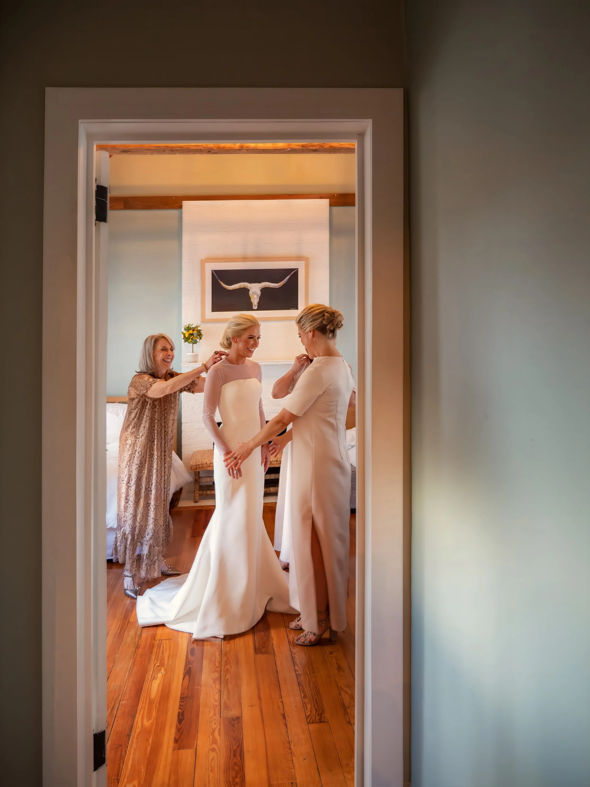 Bride prepares for her wedding with her mother and sisters inside their hotel suite.
