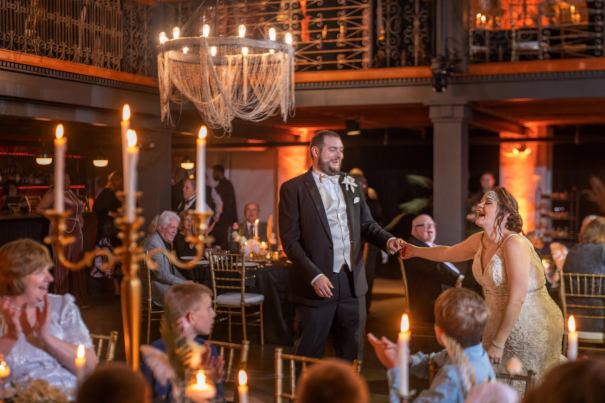 Bride and groom make their grand entrance into their wedding reception at Victory North in Savannah, Georgia during a joyful celebration photographed by Maring Visuals.