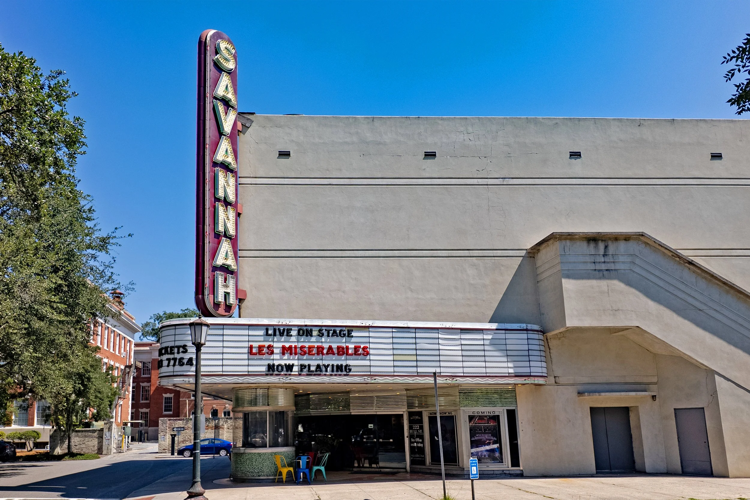 Savannah Theatre exterior with its vertical Savannah sign and a marquee advertising Les Misérables.