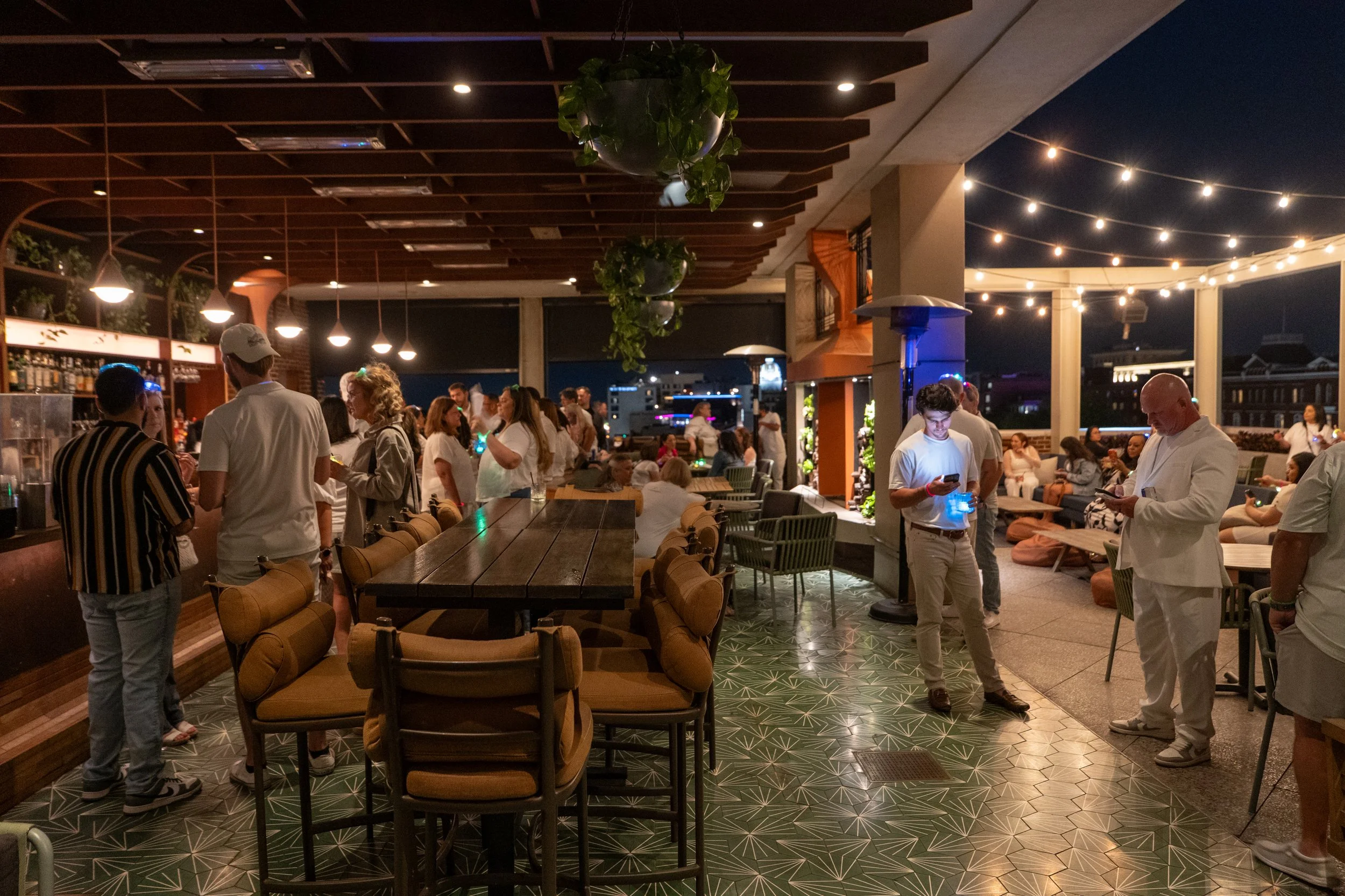 Guests relax and socialize during a rooftop after party at The Lost Square at The Alida Hotel in Savannah.