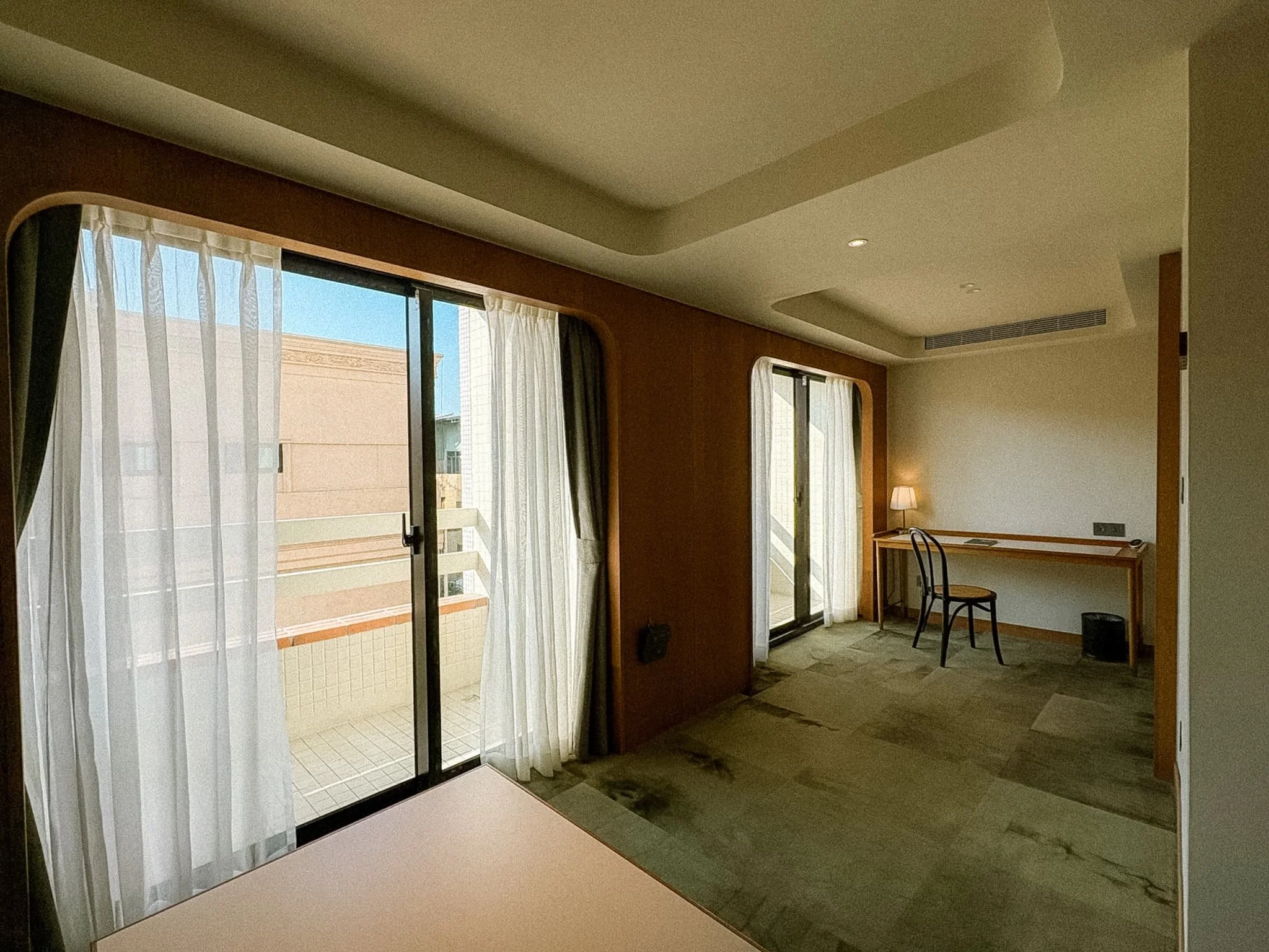 Provintia Hotel Tainan Single Room desk nook and balcony with retro wood paneling