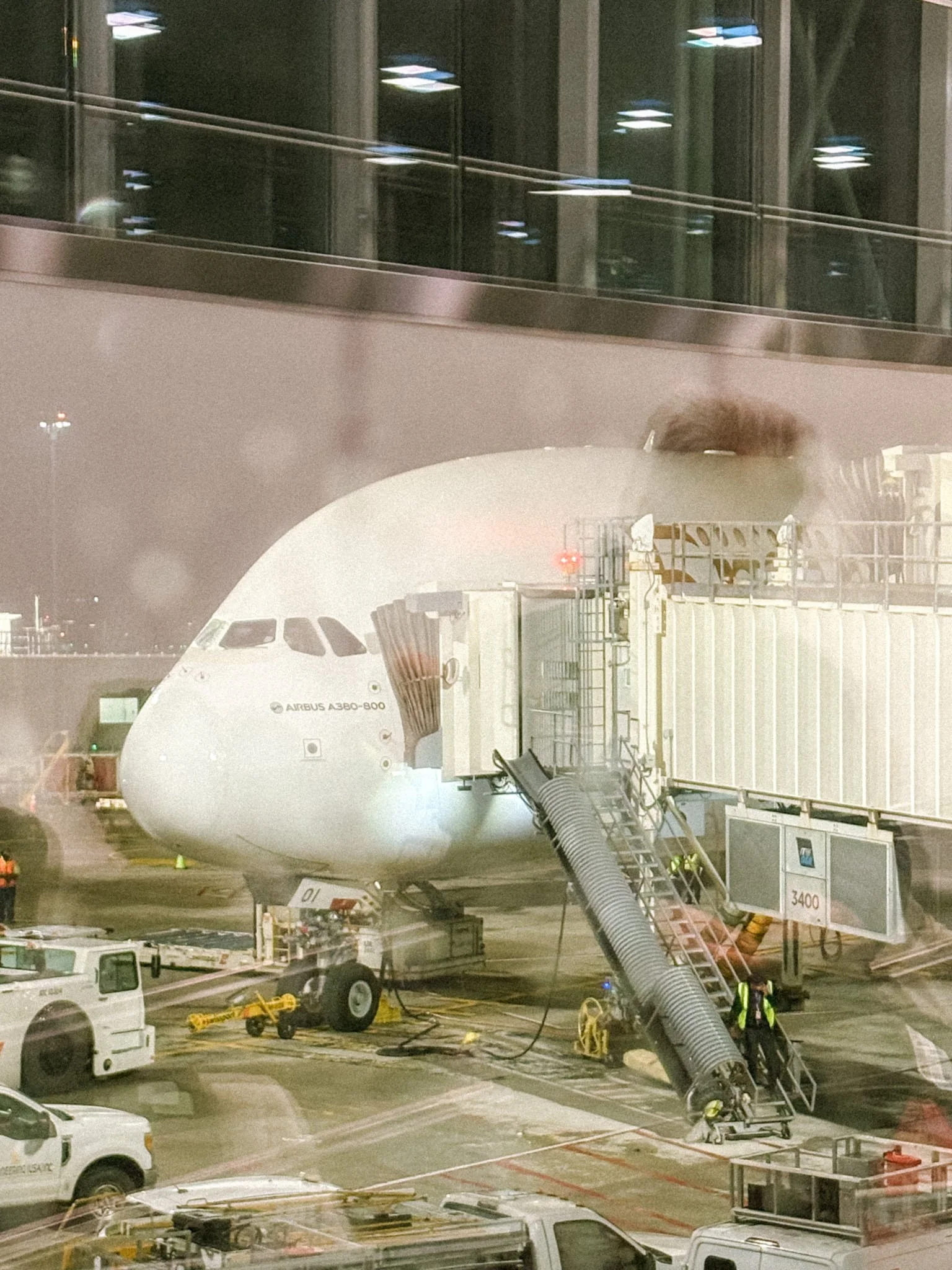 Emirates Airbus A380 double decker plane at JFK Airport gate at night