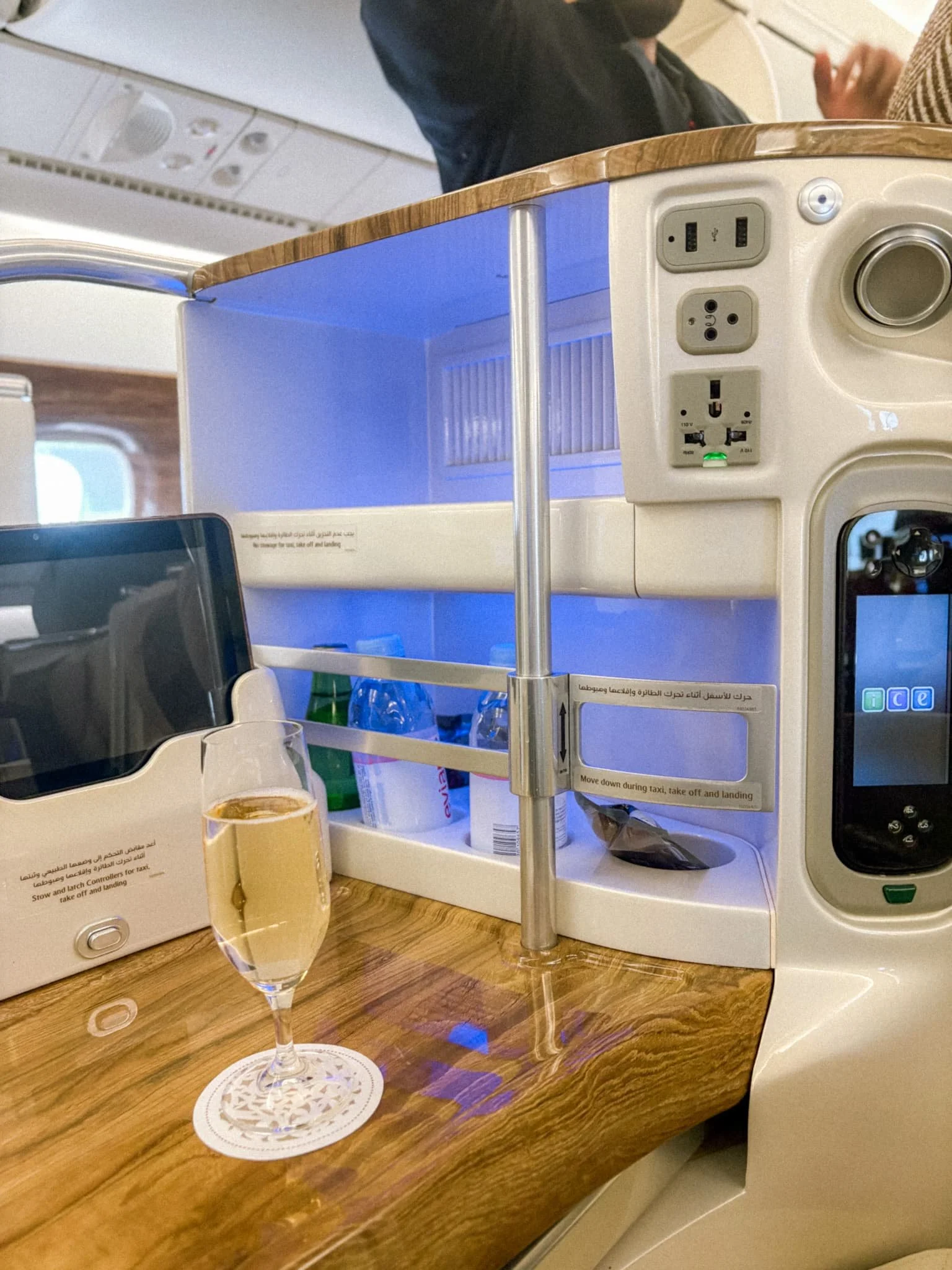 Emirates Business Class welcome champagne served in a flute on a wooden tray on the A380