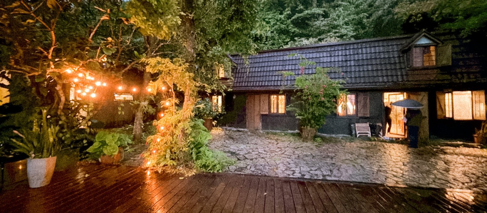 Deep Breath B&B cottage at dusk with warm lights and communal kitchen in the mountains of Hualien