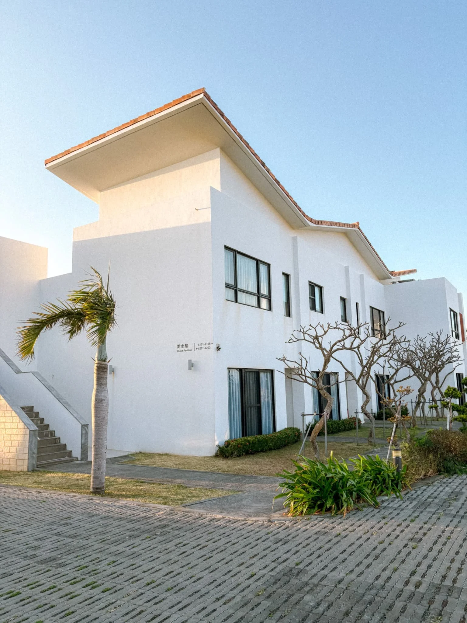 White Mediterranean-style exterior building at SkyeBay Club hotel in Kenting Taiwan under blue sky