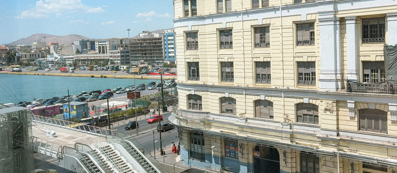 View from Port Square Hotel overlooking Piraeus ferry port, metro entrance, and cars lining up for early morning departures.