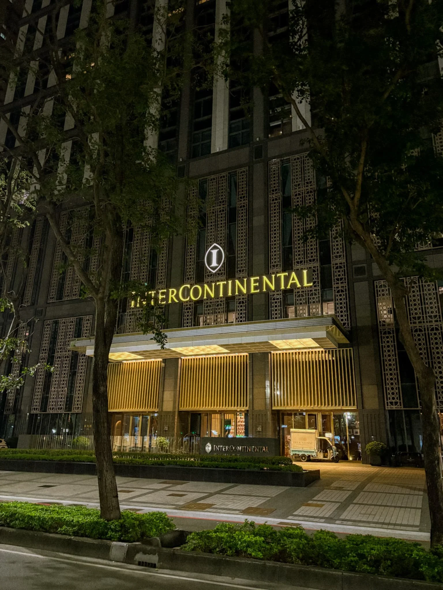 InterContinental Kaohsiung exterior at night with illuminated gold signage, luxury hotel in Taiwan