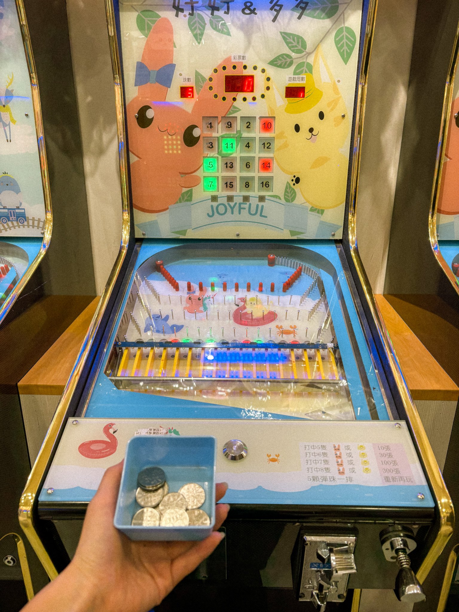 Traditional marble arcade game (彈珠台) at Raohe Night Market where players win tickets for prizes