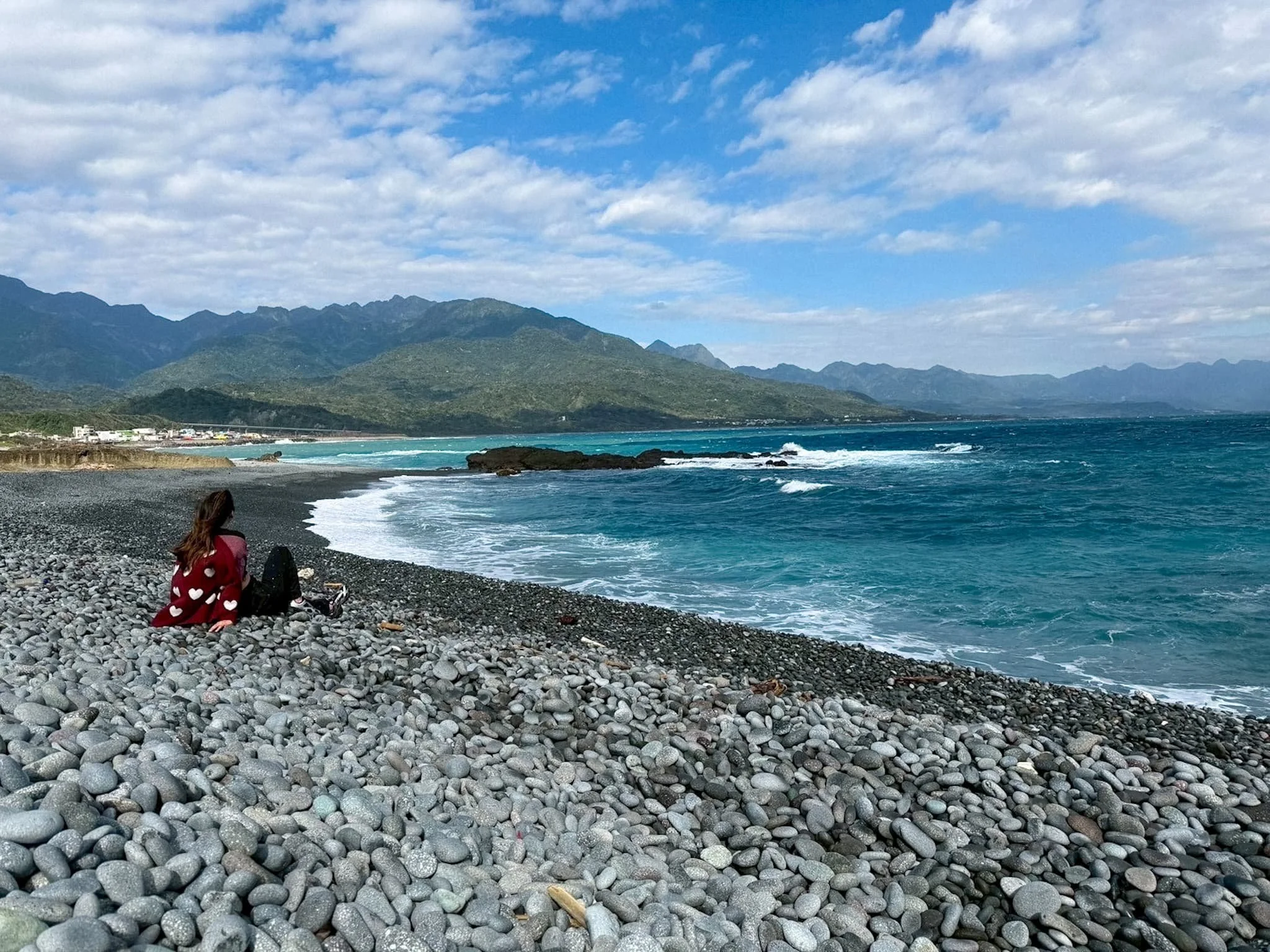 Sitting on Sanxiantai's pebble shore with mountain views along Taiwan's East Coast, Taitung