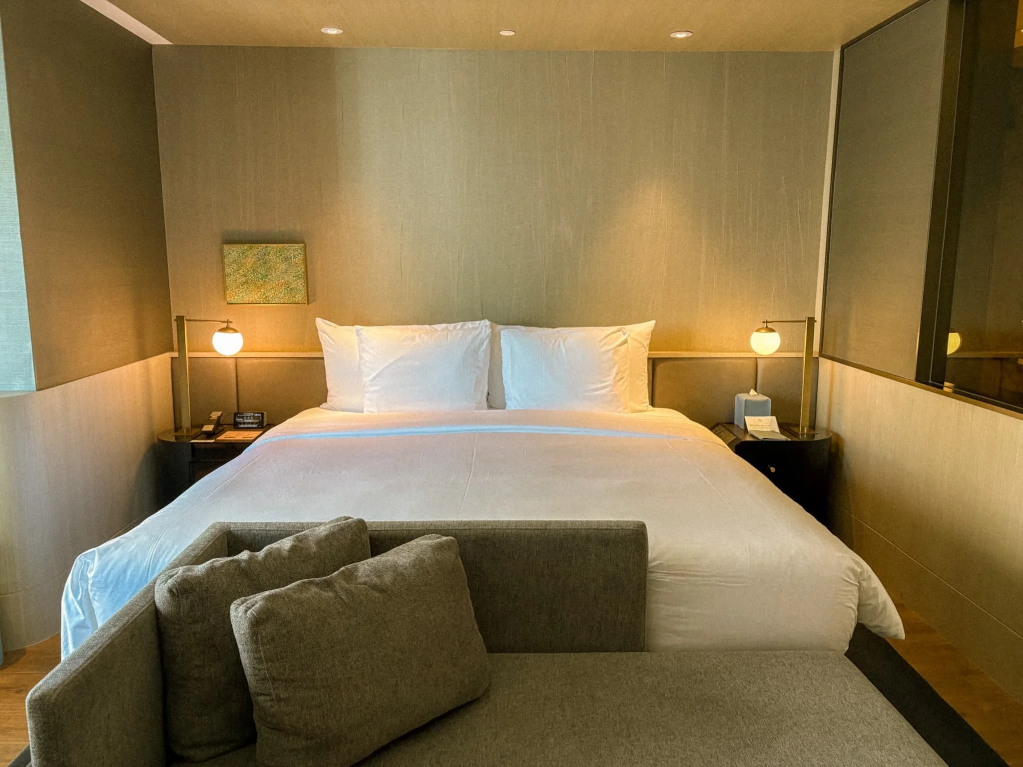 Luxury king bedroom at InterContinental Kaohsiung with warm lighting, neutral tones, and plush bedding