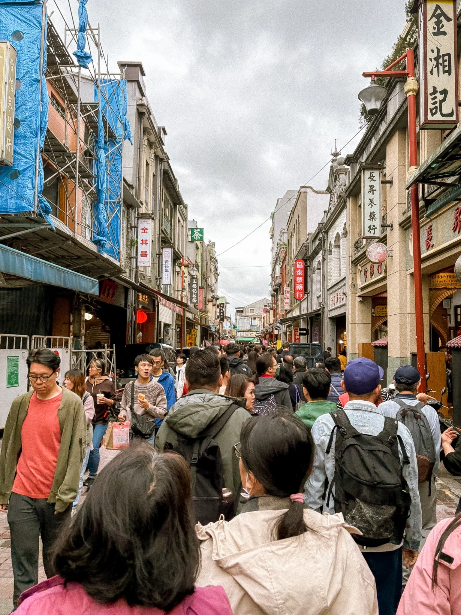 Dihua Street Taipei with locals and tourists shopping, street food, and lively market atmosphere