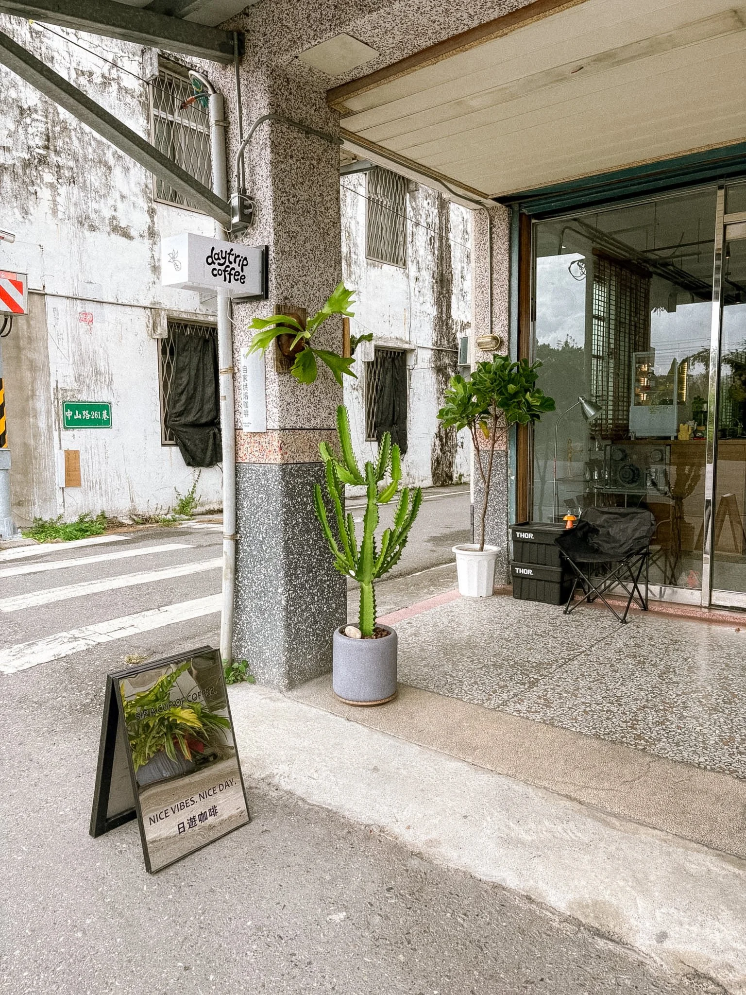 Daytrip Coffee Roasters exterior in Hualien with mirror reflecting cafe sign stand