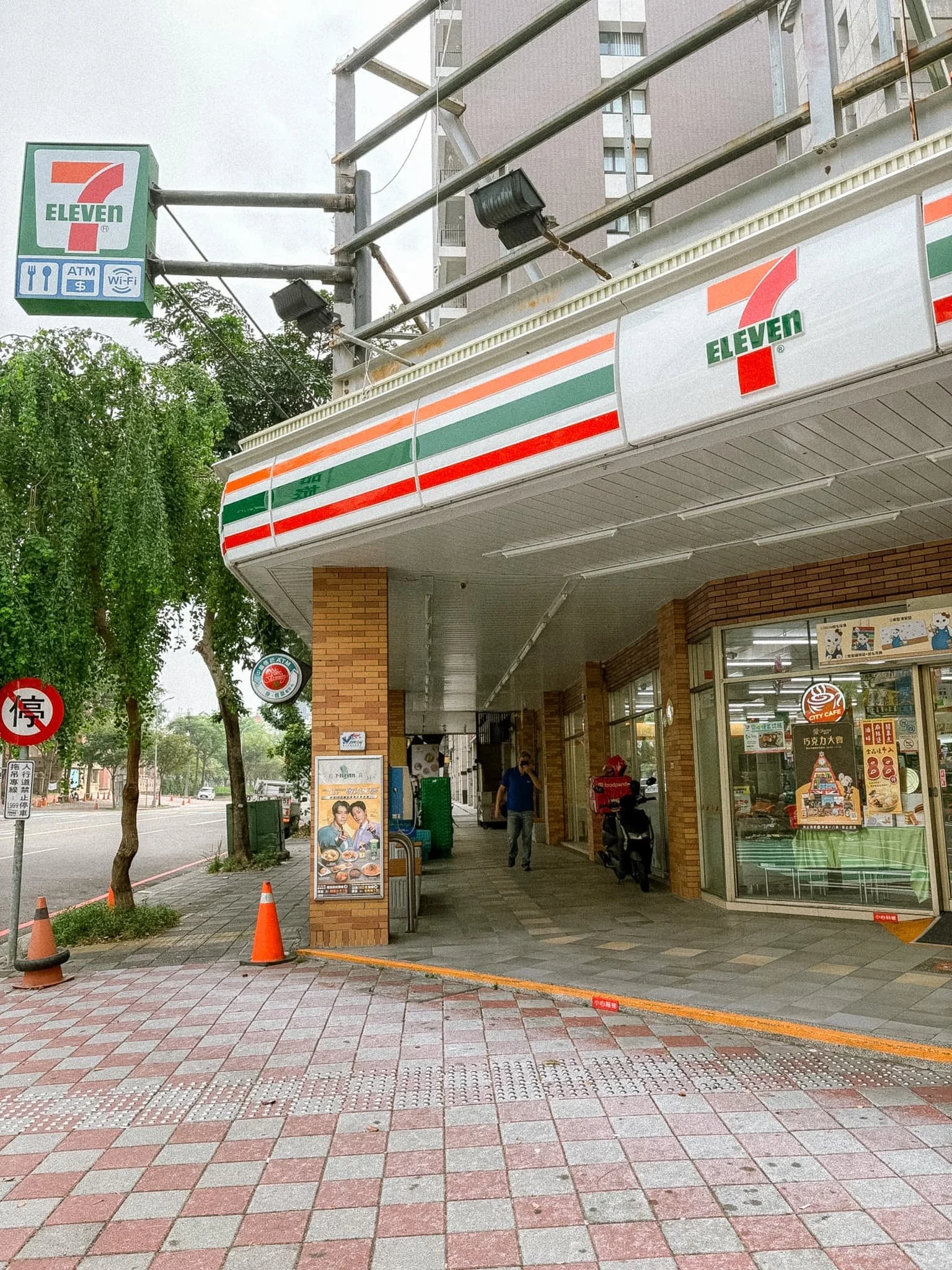 7-Eleven convenience store sign in Taiwan showing ATM, food, and Wi-Fi services available inside