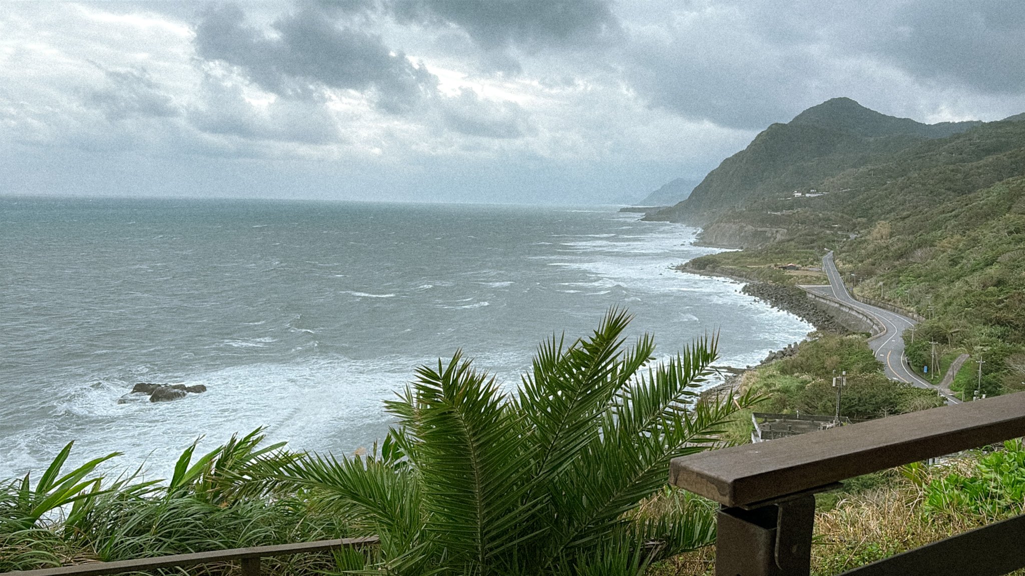 East Coast coastal road view near Dashibishan Trail with ocean, cliffs, and cloudy sky in Hualien