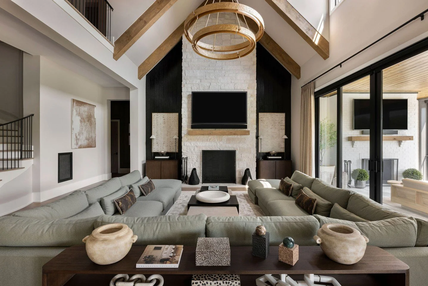 Sunday Football was definitely part of the design brief. 🏈⁠ With a house full of fans every seat needed a clear view of the action.⁠
⁠
But with soaring ceilings, creating that cozy feeling took some work on our end. We added wood beams overhead brou