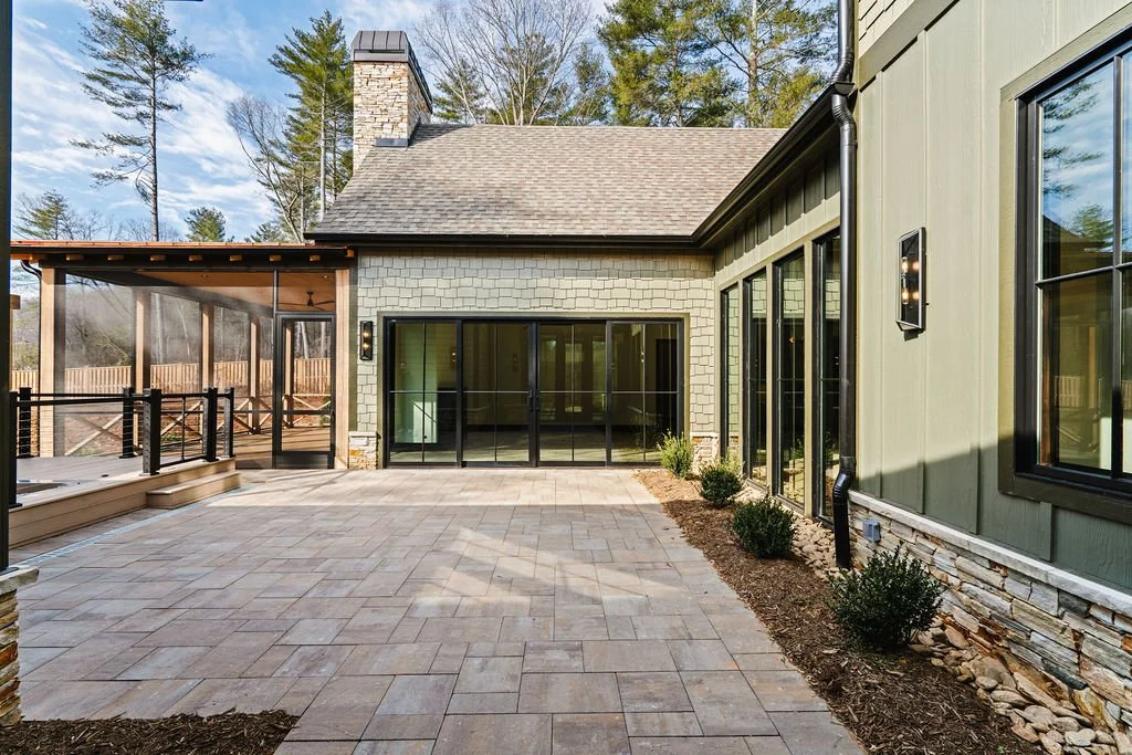 Courtyard with large glass windows and slate floor.