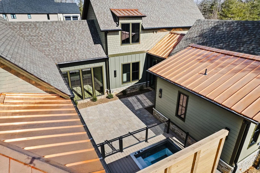 Aerial drone photo of courtyard/rooftop of custom built home.