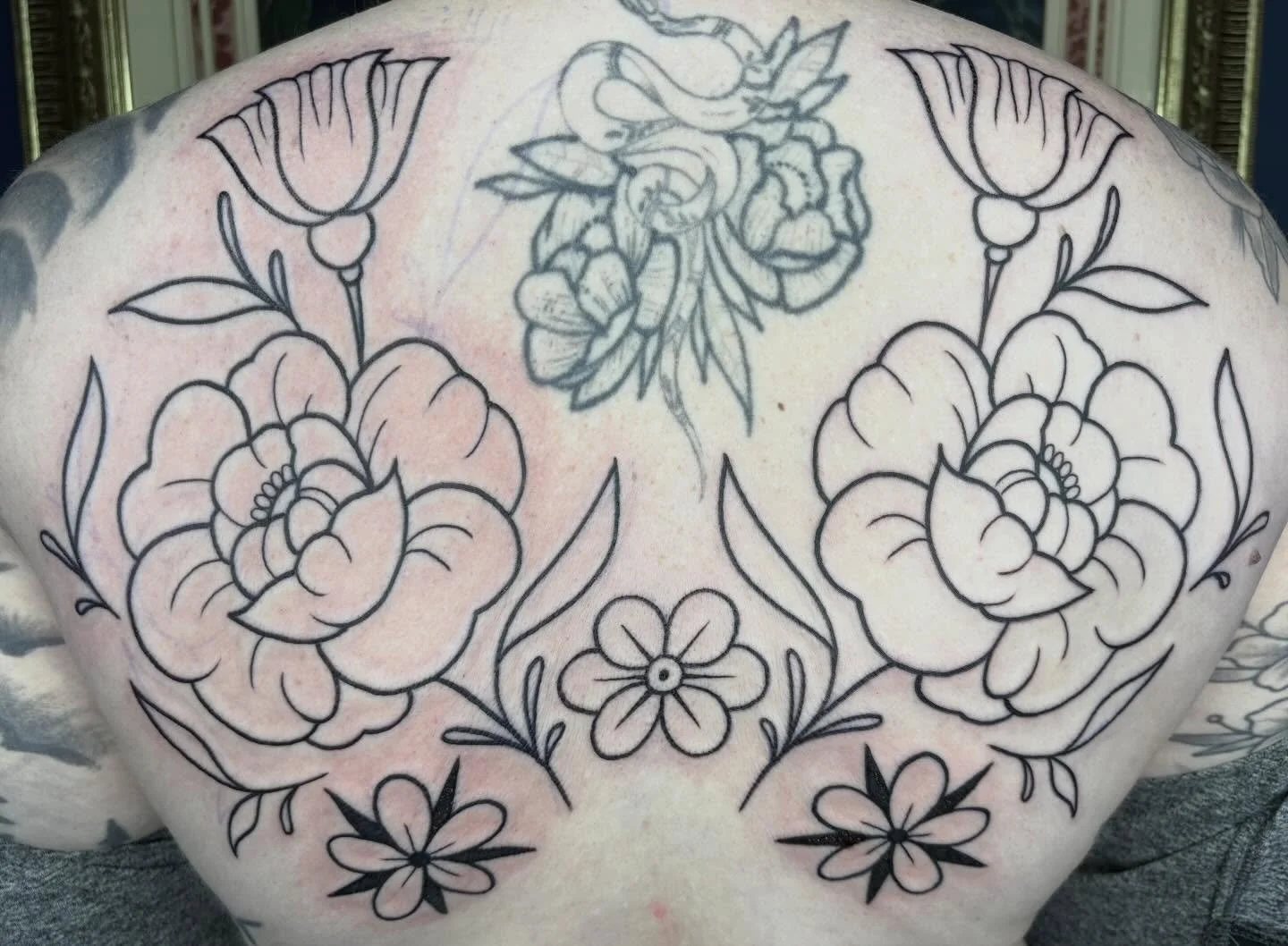 Happy snow day! Here&rsquo;s this line work only back piece I started! Can&rsquo;t wait to do the lower half! ❄️☃️☕️
.
(Snake with flowers in the middle not done by me)
.
.
.
.
.
.
.
.
#sacredarttattooct #colortattoo #blackandgreytattoo #illustration